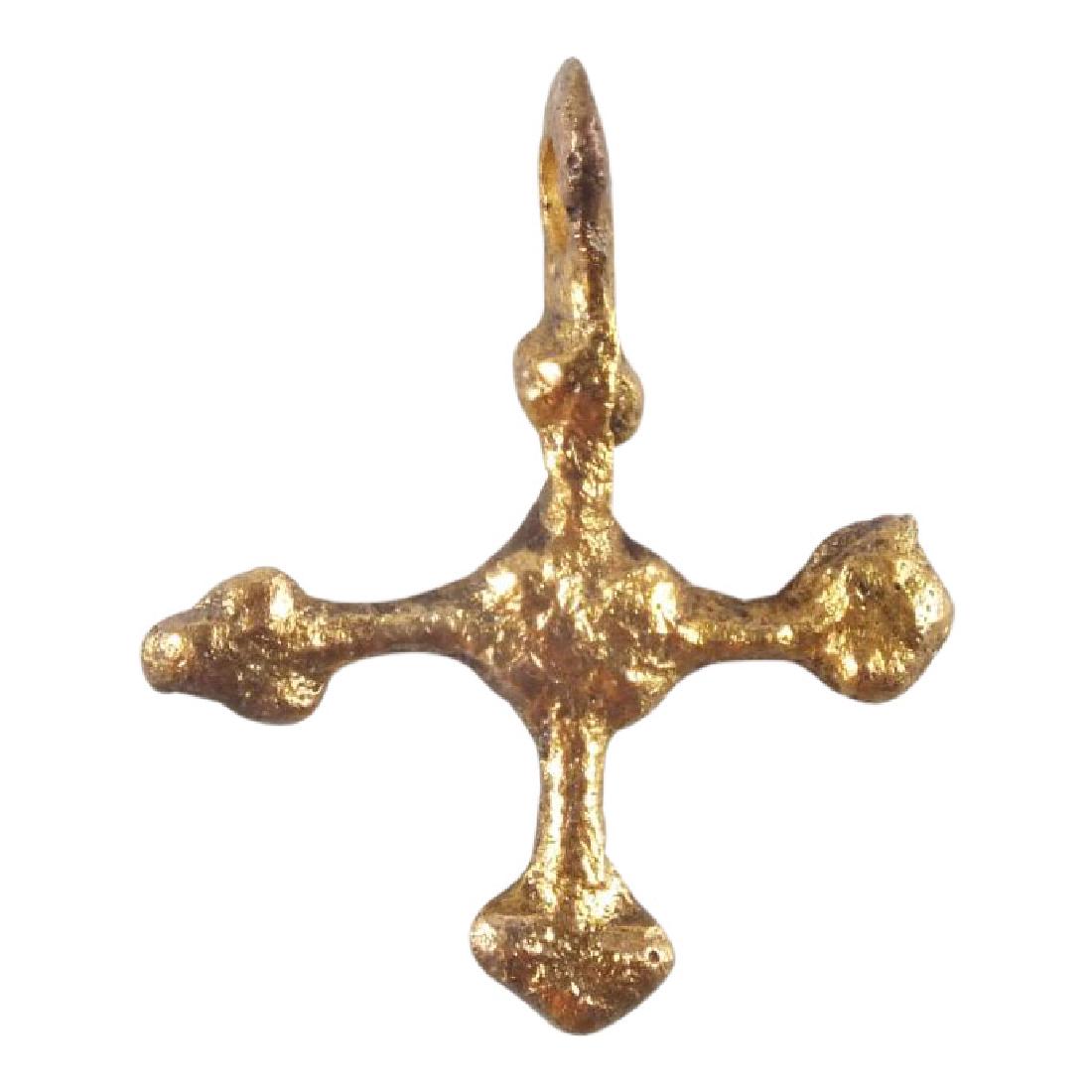 Medieval Christian Cross 11th-12h Century: Jewelry: Medieval Christian Cross Date: 11th-12h Century Material: Gilt bronze Size: Just under 1 inch tall Early Gothic form Long triple lobed terminal beams with the cross beam centered. The junctio