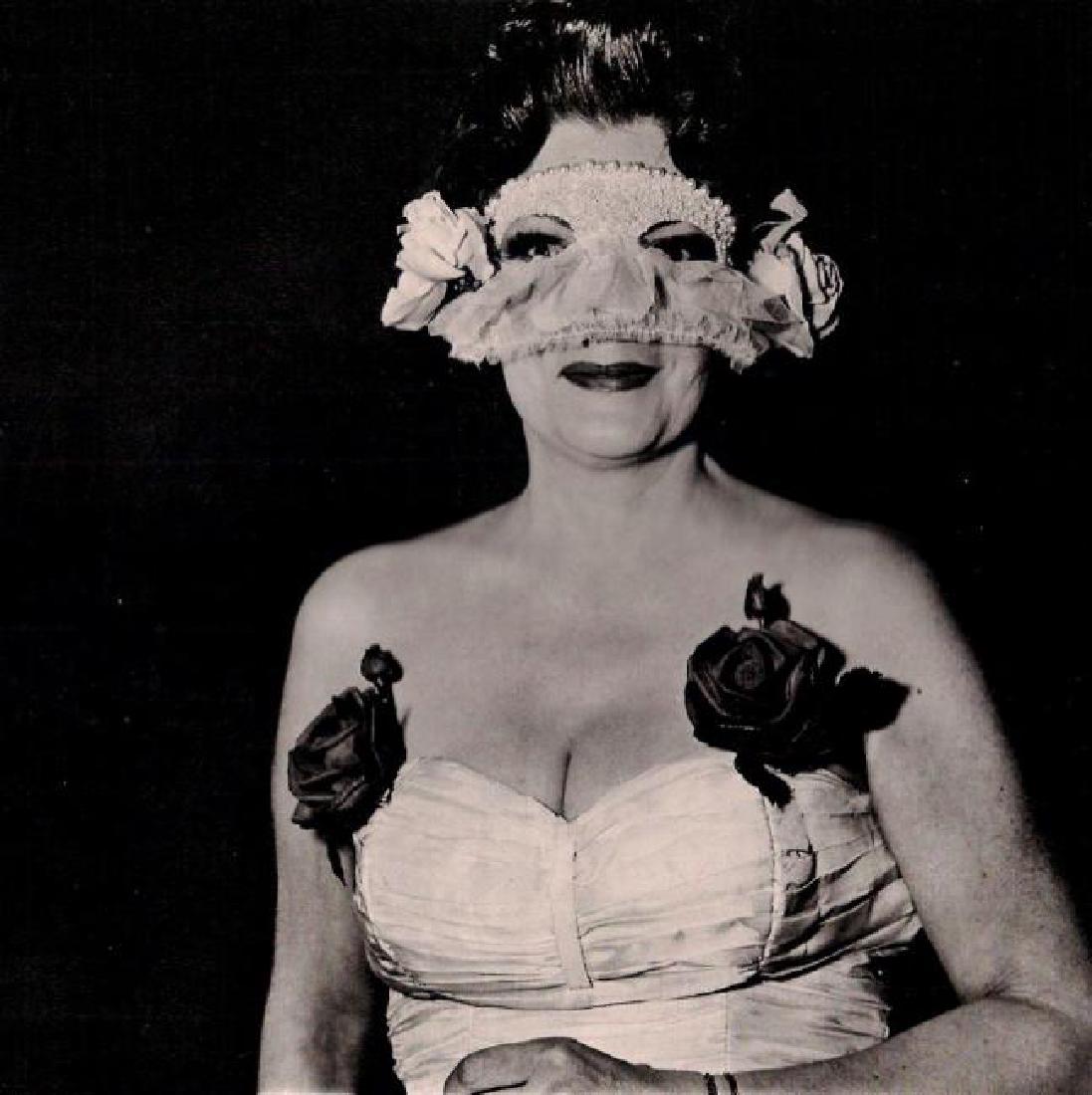 Diane Arbus: Lady at Masked Ball: Print Title: Lady at Masked Ball Artist: Diane Arbus Medium: Heliogravure with tissue guard Printing Date: 1979 Printing Location: Italy Paper Size: 15 3/4 x 11 5/8 inches Image Size: 9 7/8 x 10 inche