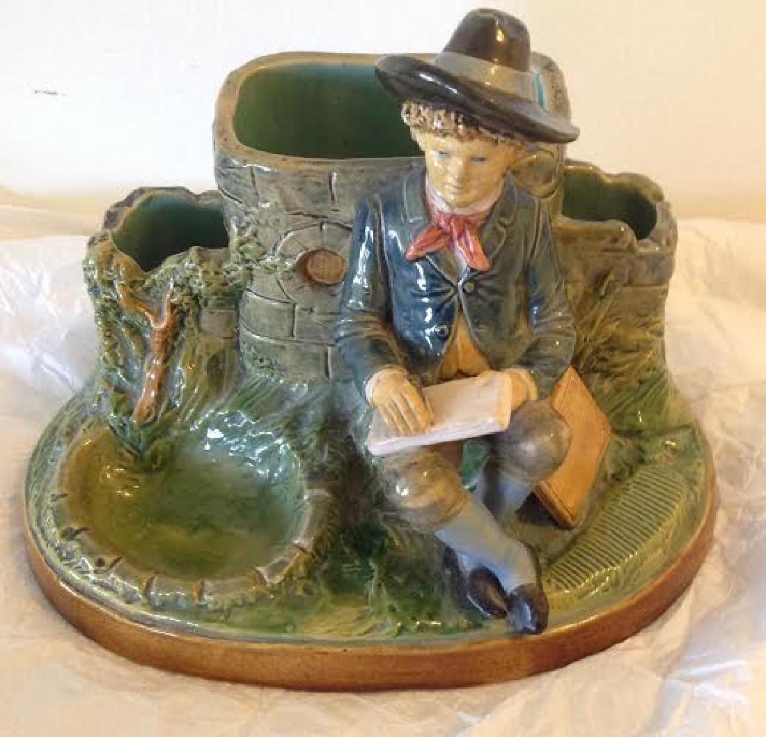 Man Seated Against Stone Majolica Figurine: Item: Man Seated Against Stone Majolica Figurine Origin: Unknown Date: Unknown Materials: Porcelain Size: 7 inches tall x 9 inches length Marked DEP "BB 2353" Please note that this lot has a reserve. 