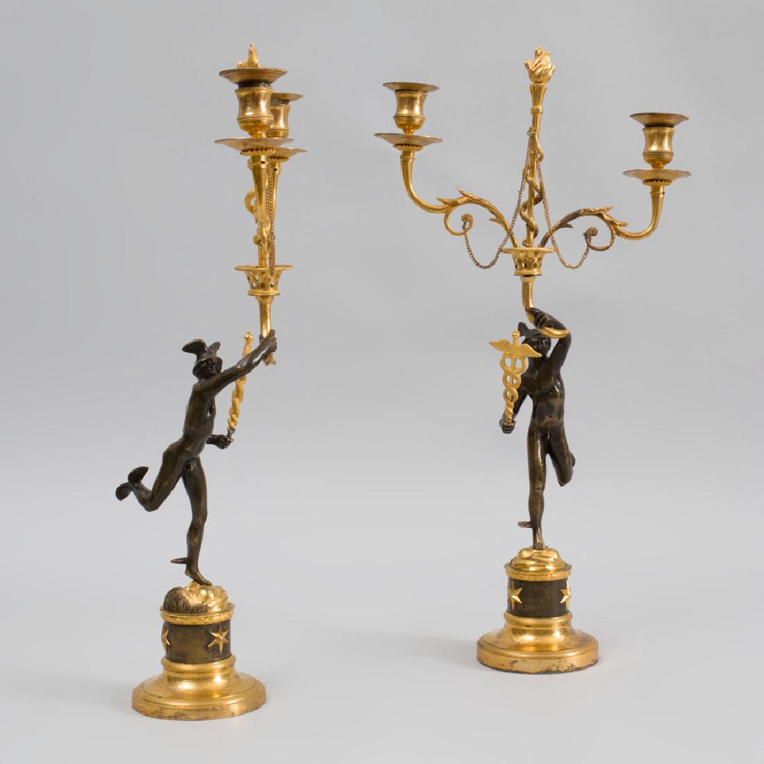 Pair of Directoire Ormolu and Patinated-Bronze Figural: Pair of Directoire Ormolu and Patinated-Bronze Figural Two-Light Candelabra Each stem modeled with Mercury, after Giambologna, the nozzles with removable drip pans. 17 3/4 x 8 3/4 in. Property from th