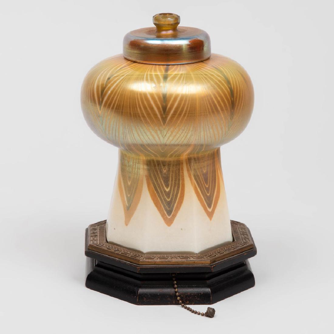 Tiffany Favrile Glass Shade Mounted as a Table Lamp: Tiffany Favrile Glass Shade Mounted as a Table Lamp The shade and cover with etched mark, on a wood base. Overall 8 x 5 in. diam. The Collection of Judith & Gerson Leiber
