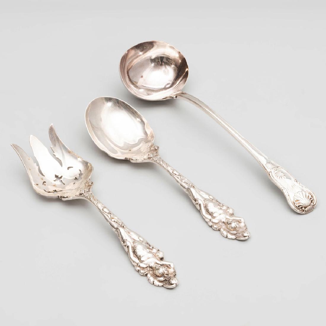 Pair of Reed & Barton Silver Servers in the 'Love: Pair of Reed & Barton Silver Servers in the 'Love Disarmed' Pattern, and a Victorian Silver Ladel The pair marked 'Sterling'; the ladel with mark of William Theobalds, London, 1841. The pair 10 1
