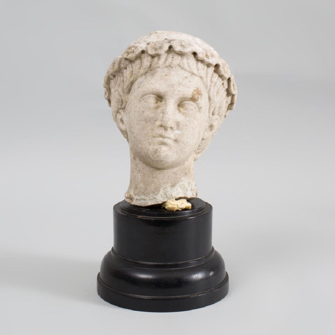 Roman Style Carved Marble Head of a Youth: Roman Style Carved Marble Head of a Youth Mounted on an ebonized wood pedestal. 9 in. high, overall 13 1/2 in. high. Property from the Estate of Ralph Vuolo, Greenwich, CT