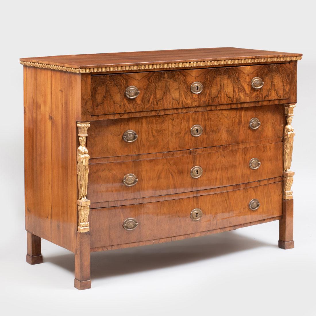 Austrian Neoclassical Walnut and Parcel-Gilt Chest of: Austrian Neoclassical Walnut and Parcel-Gilt Chest of Drawers Fitted with one deep drawer above four bow-fronted drawers and later gilt-metal handles and escutcheons. 40 1/2 x 51 1/4 x 24 1/4 in.