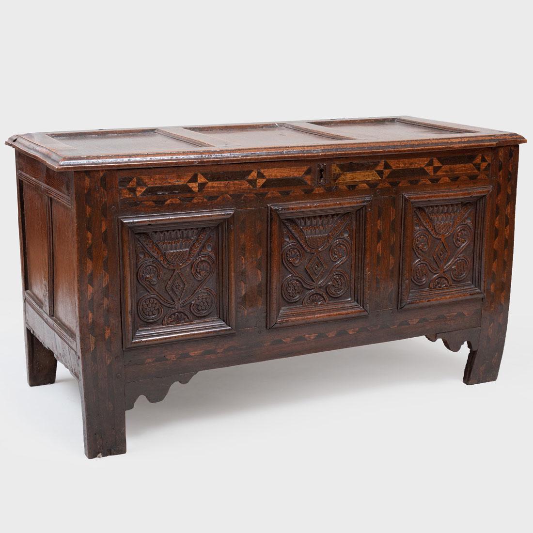 Charles II Inlaid and Carved Oak Chest: Charles II Inlaid and Carved Oak Chest The inlay and carved panels of later date. The hinged top opening to a welled interior with blue paper, raised on block feet. Lock plate replaced. 27 x 48 1/4 x