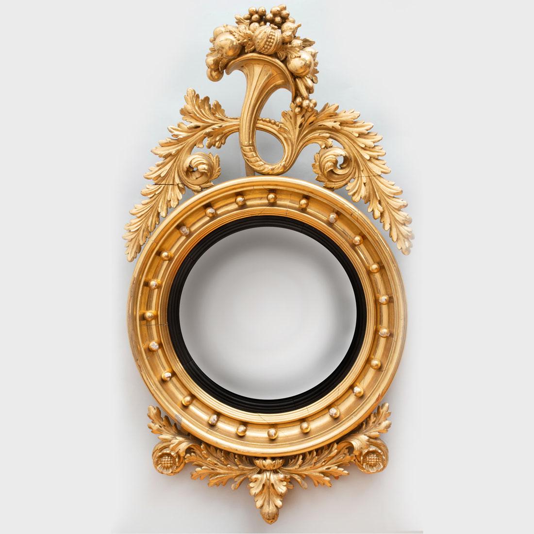 Fine Federal Giltwood and Ebonized Convex Mirror: Fine Federal Giltwood and Ebonized Convex Mirror Fitted with a central convex mirror plate surmounted by a fruit-filled cornucopia issuing acanthus leaves, terminating in a foliate scroll. 50 x 29 in.