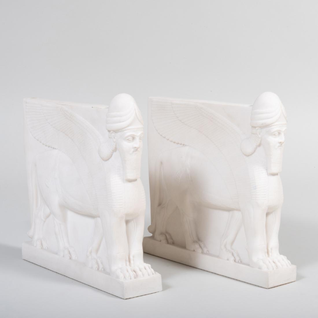 Pair of Copeland Parian Porcelain Assyrian Style Book: Pair of Copeland Parian Porcelain Assyrian Style Book Ends Impressed mark and printed retailer mark for Alfred Jarvis. 9 1/4 x 9 1/4 x 2 in. Note: The book ends are based on the colossal guardian figu