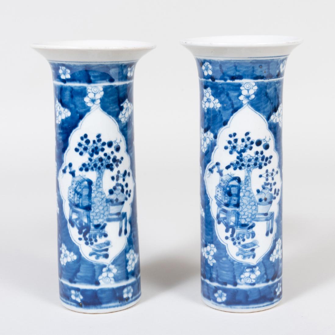 Pair of Chinese Porcelain Blue and White Beaker Vases: Pair of Chinese Porcelain Blue and White Beaker Vases Decorated with scholar's objects. 11 x 5 in. diam.