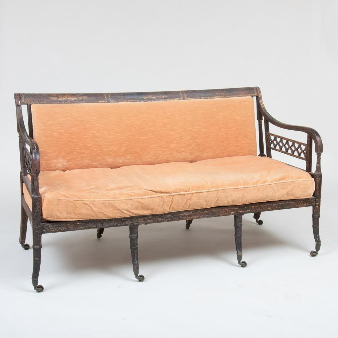 Regency Painted and Caned Settee: Regency Painted and Caned Settee Fitted with a loose upholstered cushion and backrest, raised on casters. 36 x 62 3/4 x 27 in.