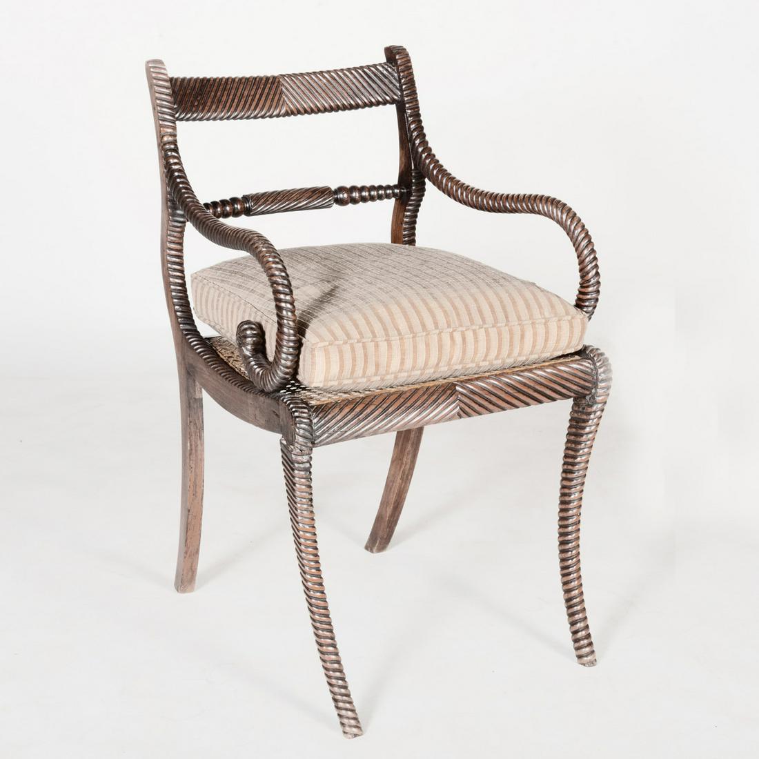Regency Carved Walnut and Faux Grained Armchair, in the: Regency Carved Walnut and Faux Grained Armchair, in the Anglo-Indian Taste Fitted with a caned seat with loose cushion. 31 3/4 x 19 1/2 x 23 1/2 in.