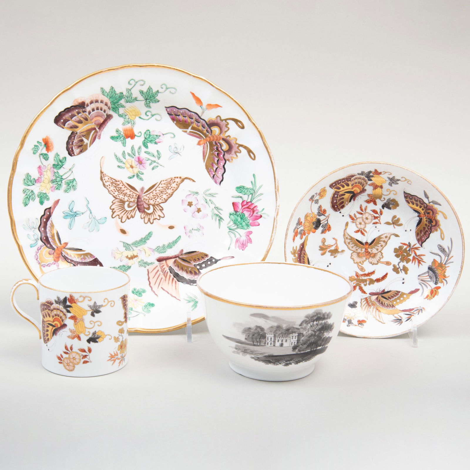 Group of Wedgwood Porcelain Tablewares: Group of Wedgwood Porcelain Tablewares Red printed mark. Comprising: A coffee can and saucer A plate painted with butterflies A waste bowl and plate painted in black momchrome by John Cutts The plate