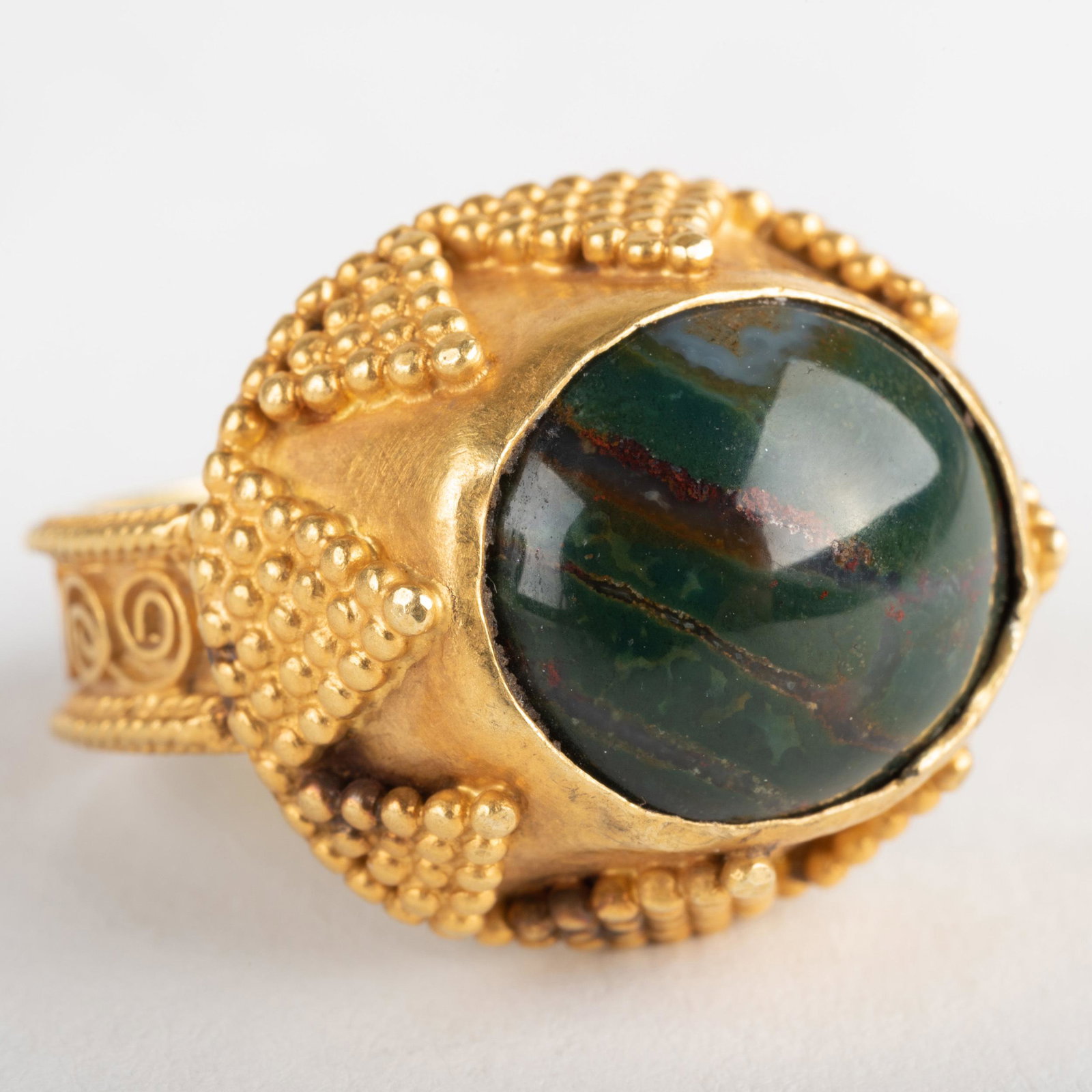 22k Granulated Gold and Blood Stone Ring: 22k Granulated Gold and Blood Stone Ring Size 8, 6.9 dwts. p> Sold Stair Galleries, The Collection of Patti Cadby Birch, December 6, 2008, Lot 386.