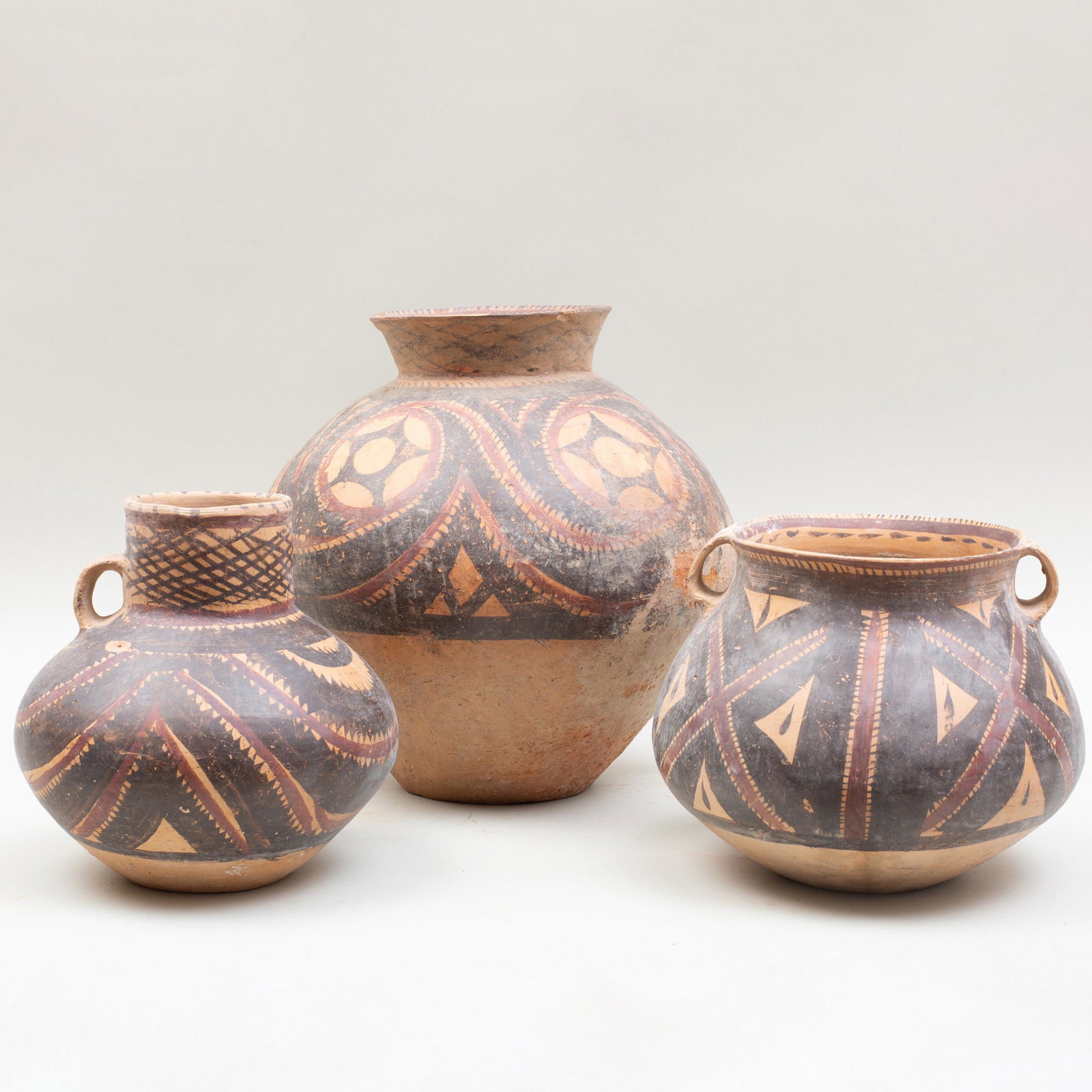 Group of Three Chinese Neolithic Painted Pottery: Group of Three Chinese Neolithic Painted Pottery Vessels Largest: 12 1/4 x 13 3/4 x 11 1/2 in. p> Private Collection of Mr. P. Wong, Elegance Gallery, Hong Kong, 1993. Property from a Private Collecto