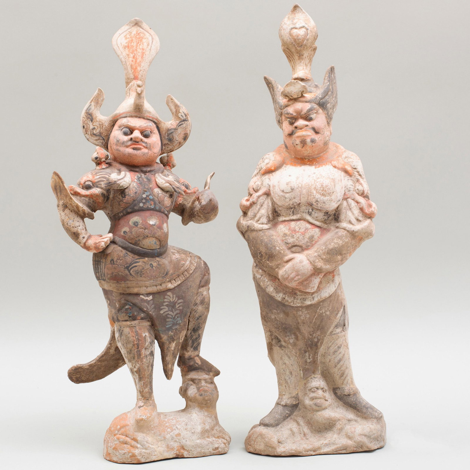 Two Chinese Painted Pottery Figures of Tomb Guardians: Two Chinese Painted Pottery Figures of Tomb Guardians The larger 21 1/2 in. high. p> Private Collection of Mr. P. Wong, Elegance Gallery, Hong Kong, 1993. Property from a Private Collector, Chatham, N