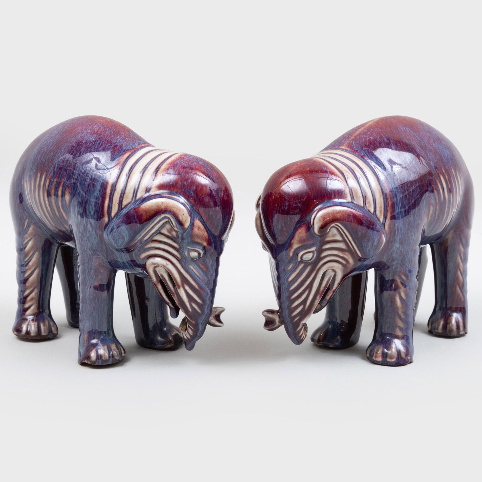 Pair of Chinese Flambe Glazed Earthenware Models of: Pair of Chinese Flambe Glazed Earthenware Models of Elephants 8 in. high. p> Property from a Distinguished New York City Collector