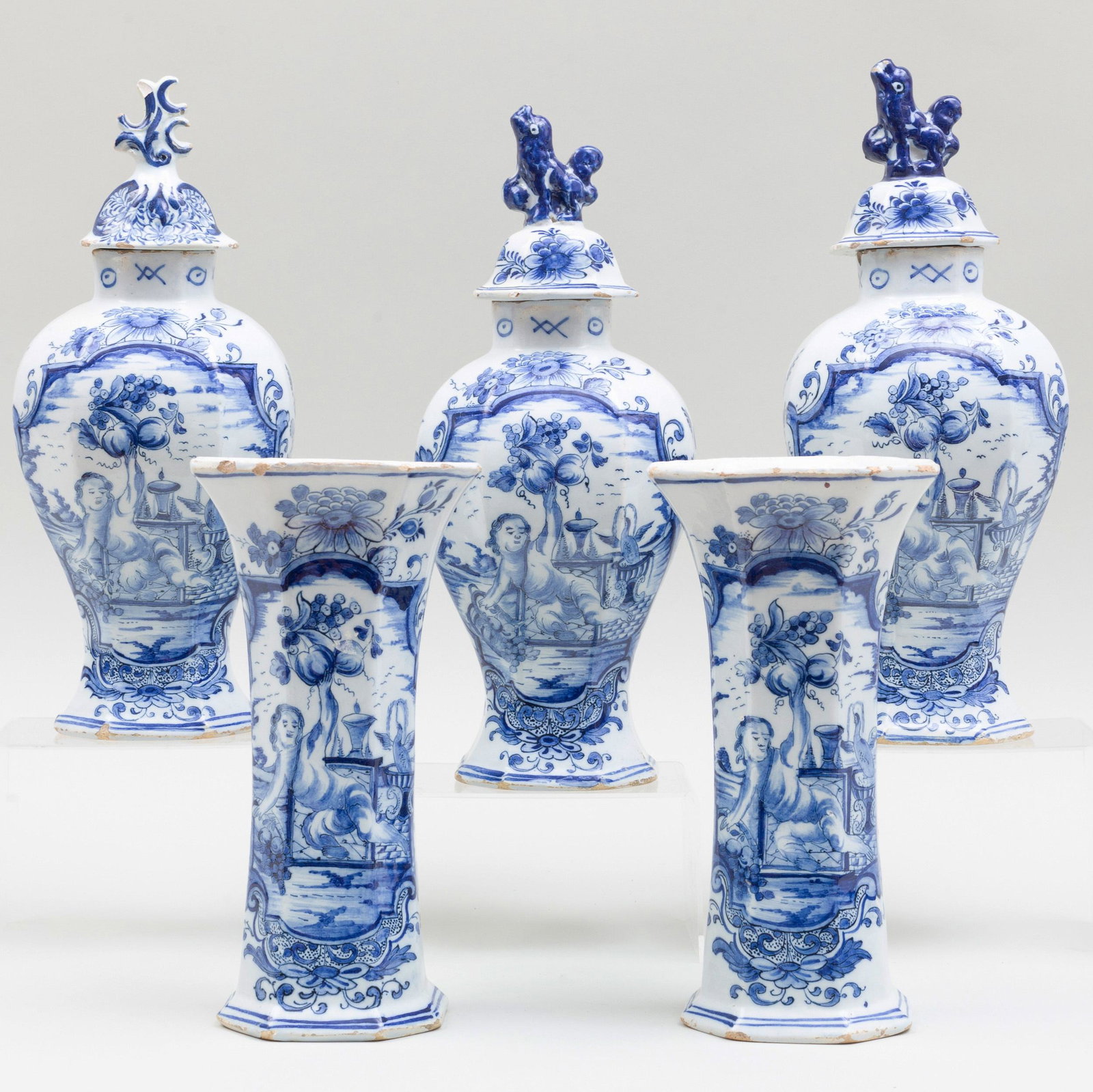 Blue and White Delft Five Piece Garniture: Blue and White Delft Five Piece Garniture Comprising: Three vases and covers Two beaker vases The largest 14 1/4 in. high. p> Vernay and Jussel, NY.