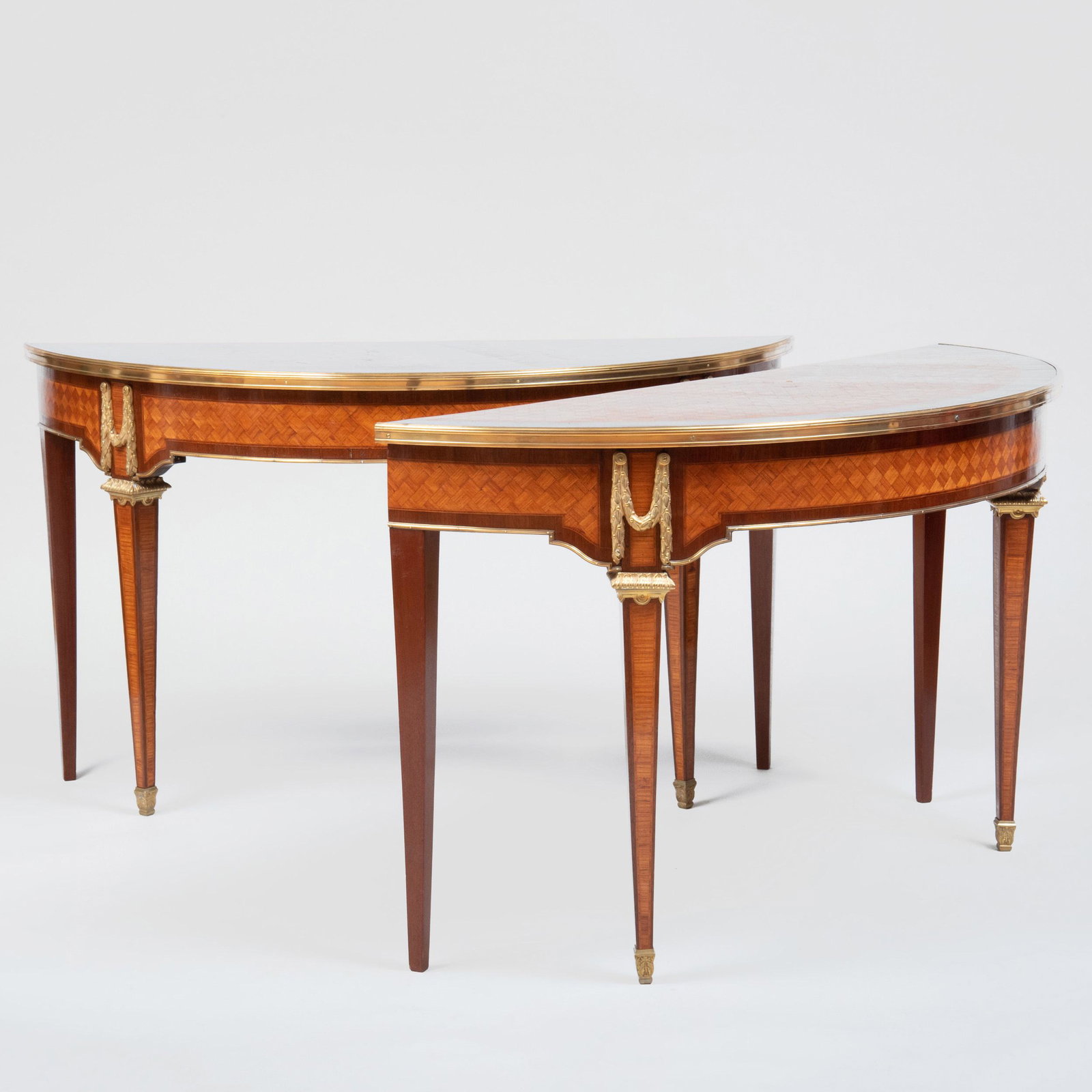 Pair of Louis XVI Style Gilt-Bronze-Mounted Tulipwood: Pair of Louis XVI Style Gilt-Bronze-Mounted Tulipwood Parquetry D-Shaped Consoles Each fitted with ormolu borders, berried swags, collars and sabots within tulipwood parquetry panels within mahogany b