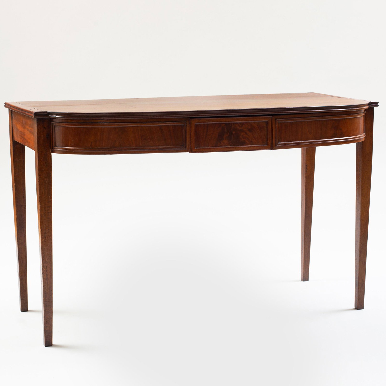 George III Mahogany Serving Table: George III Mahogany Serving Table The bow-fronted top fitted with three drawers, raised on tapered legs. 29 3/4 x 24 1/2 x 47 3/4 in. p>