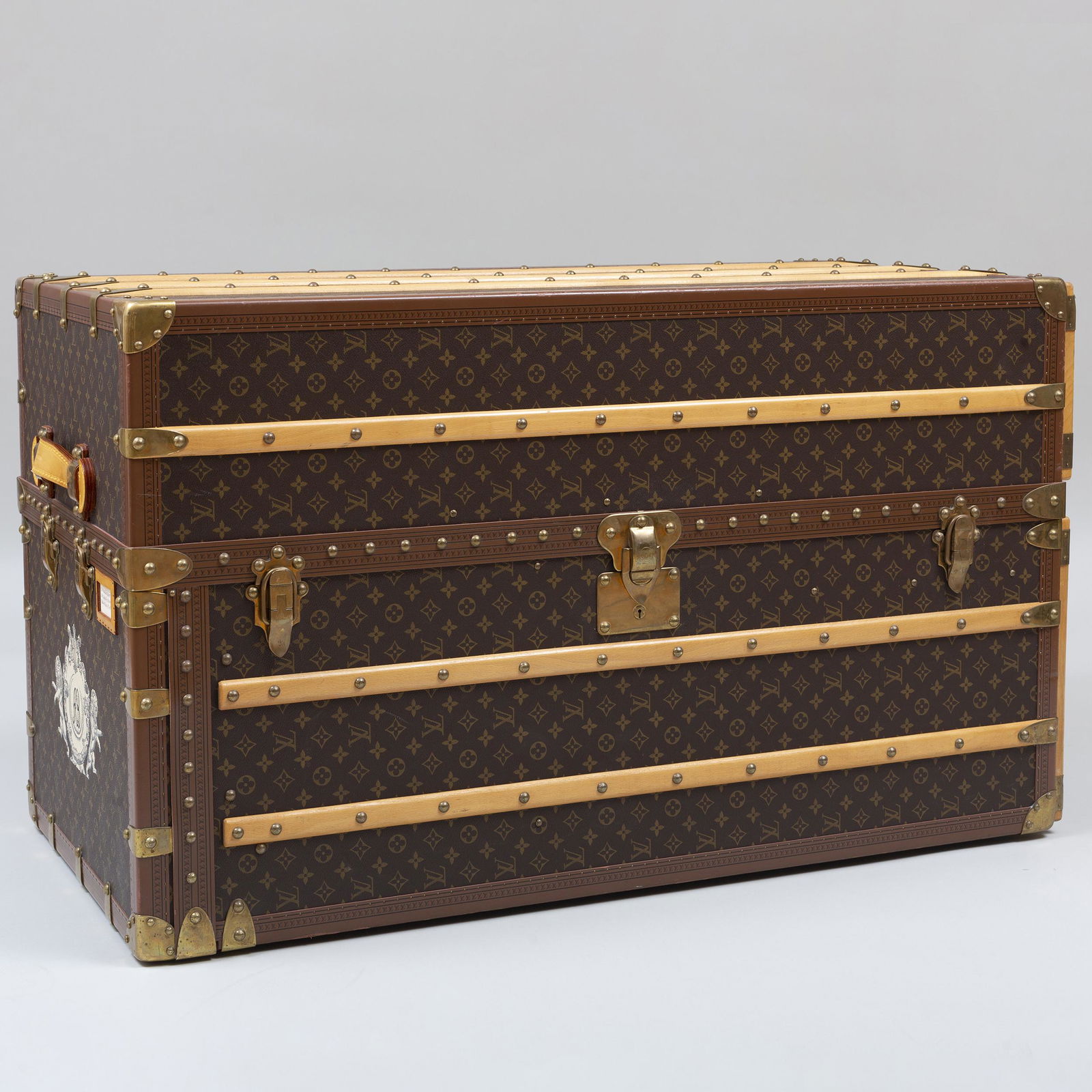Louis Vuitton Wardrobe Trunk: Serial number AA1083716, monogrammed AB within an armorial device. Fully marked on hardware, leather handles and wood trim; the interior fitted with six drawers, a shoe compartment, metal hanging rod,