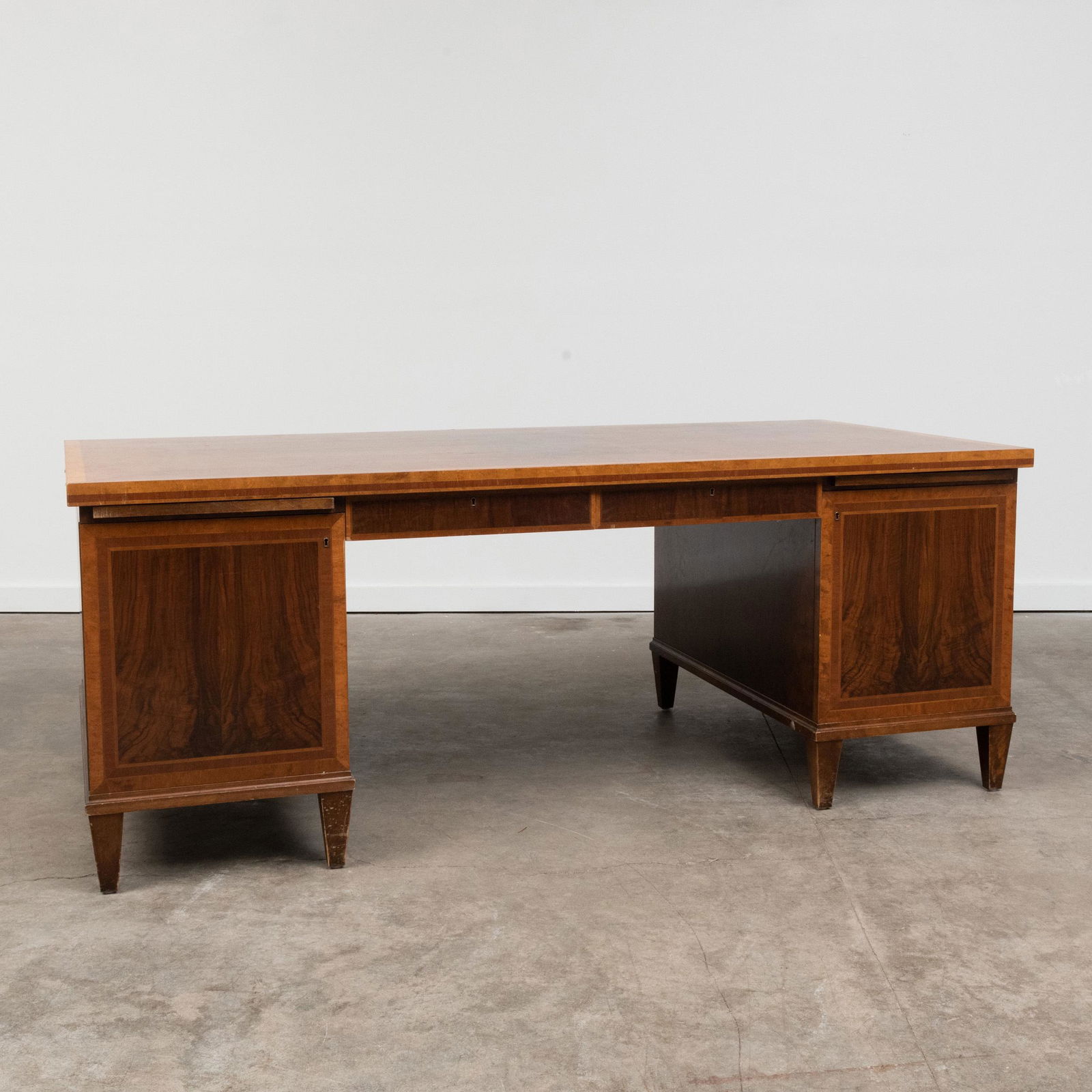 Carl Malmsten Inlaid Fruitwood and Burl Partners Desk: Carl Malmsten Inlaid Fruitwood and Burl Partners Desk One side fitted with two short drawers, the other with writing slides over two cupboards with fitted interiors. 31 x 6 ft. 5 in. x 39 1/2 in. B