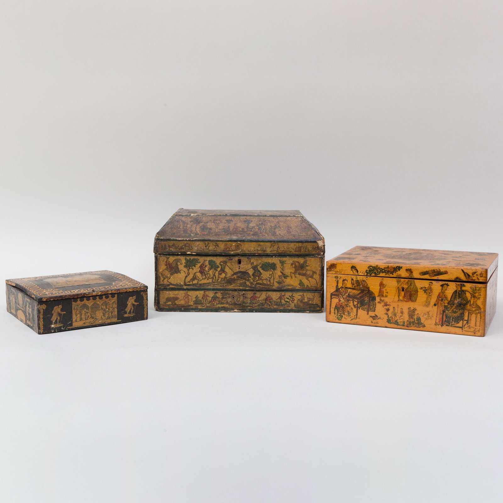 Two Decalcomania Boxes and a Transfer Decorated Box: Two Decalcomania Boxes and a Transfer Decorated Box The first painted wood with a two compartment interior, the second papier mâchè fitted with a drawer, the third stained wood with a fabric lined c