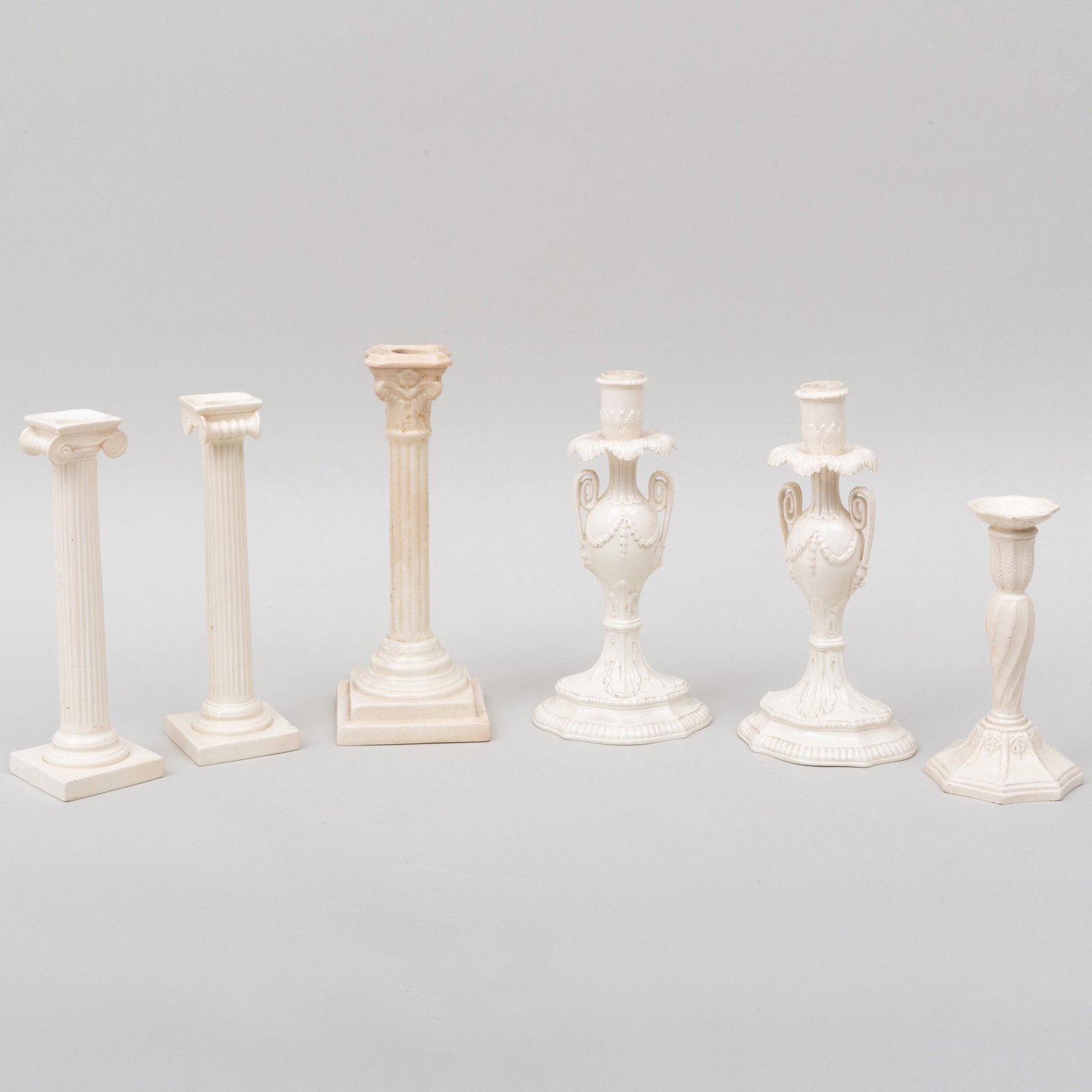 Group of Six Creamware Candlesticks: Group of Six Creamware Candlesticks Various marks. Comprising: A pair of two handle candlesticks A fluted candlestick A pair of ionic columnar candlesticks A Corinthian columnar candlestick The talles