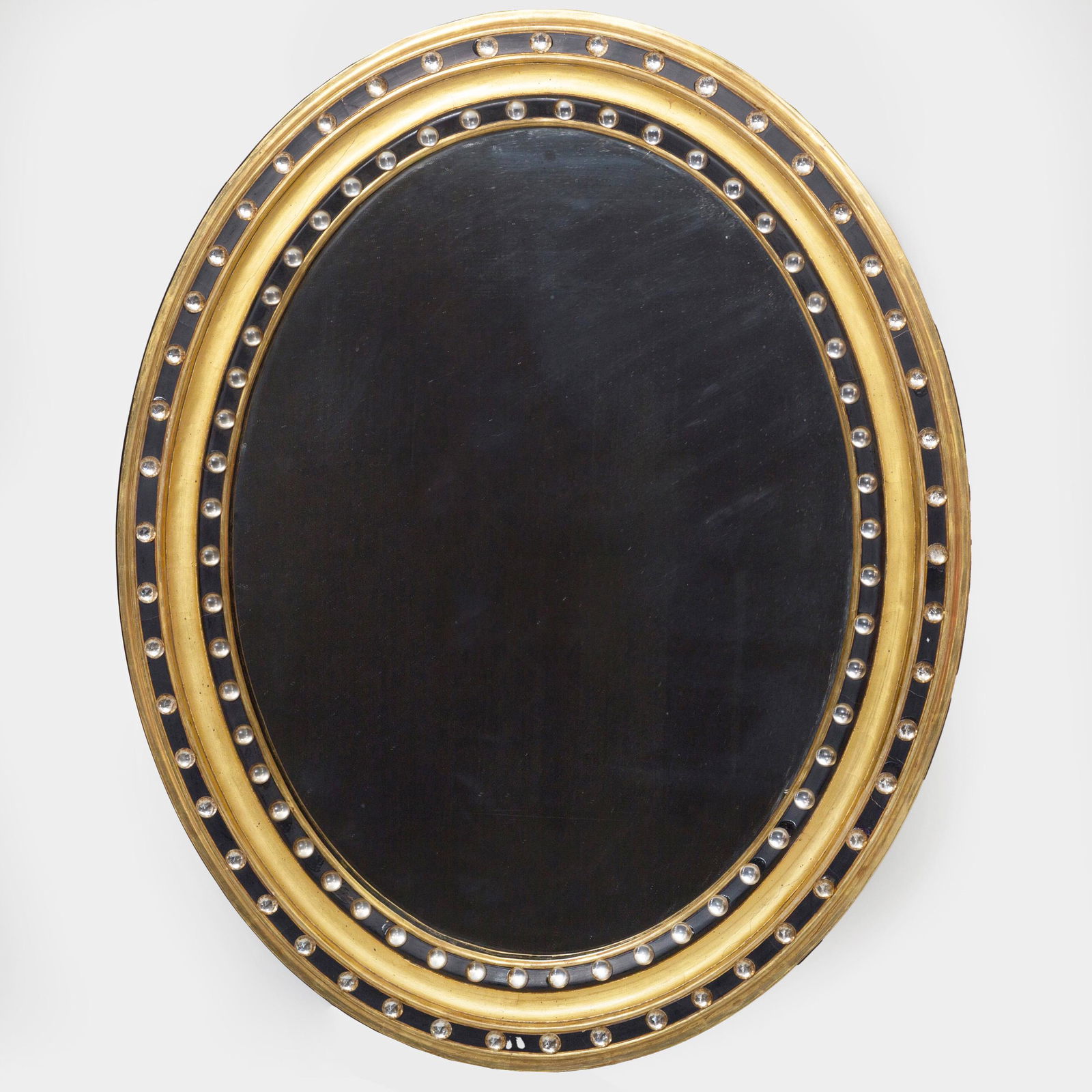Irish Ebonized Parcel-Gilt and Beaded Glass Mirror: Irish Ebonized Parcel-Gilt and Beaded Glass Mirror With a paper label, 'H. Mawer & Stephenson, Ltd., Depository, London, S. W., Mr. S. Heynes, Esq.'. 29 1/2 x 24 in.