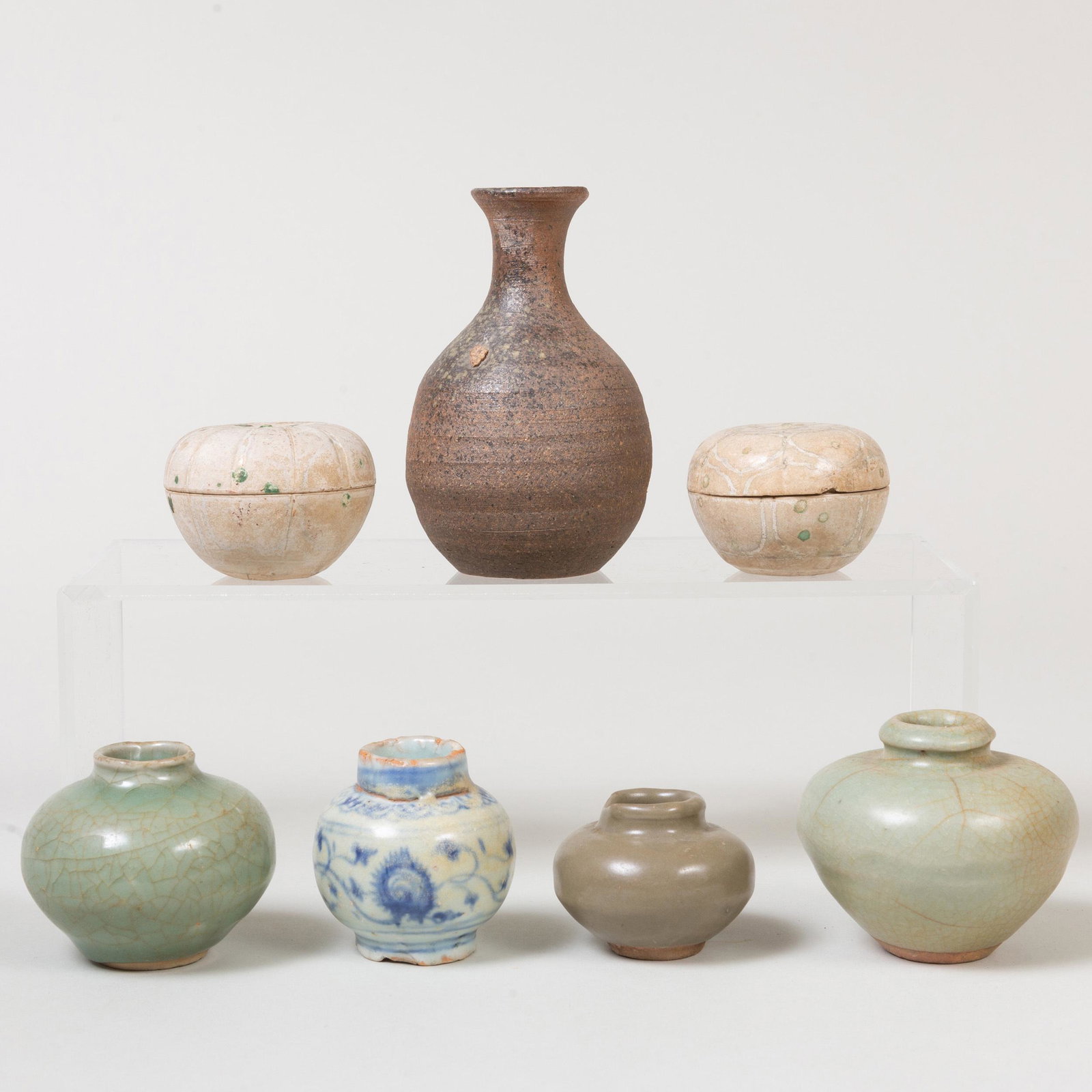 Group of Chinese Porcelain Vessels: Group of Chinese Porcelain Vessels Comprising: Three celadon glazed jarlets A blue and white glazed jarlet Two circular boxes and covers Together with an earthenware vase The largest celadon vase 2 3/