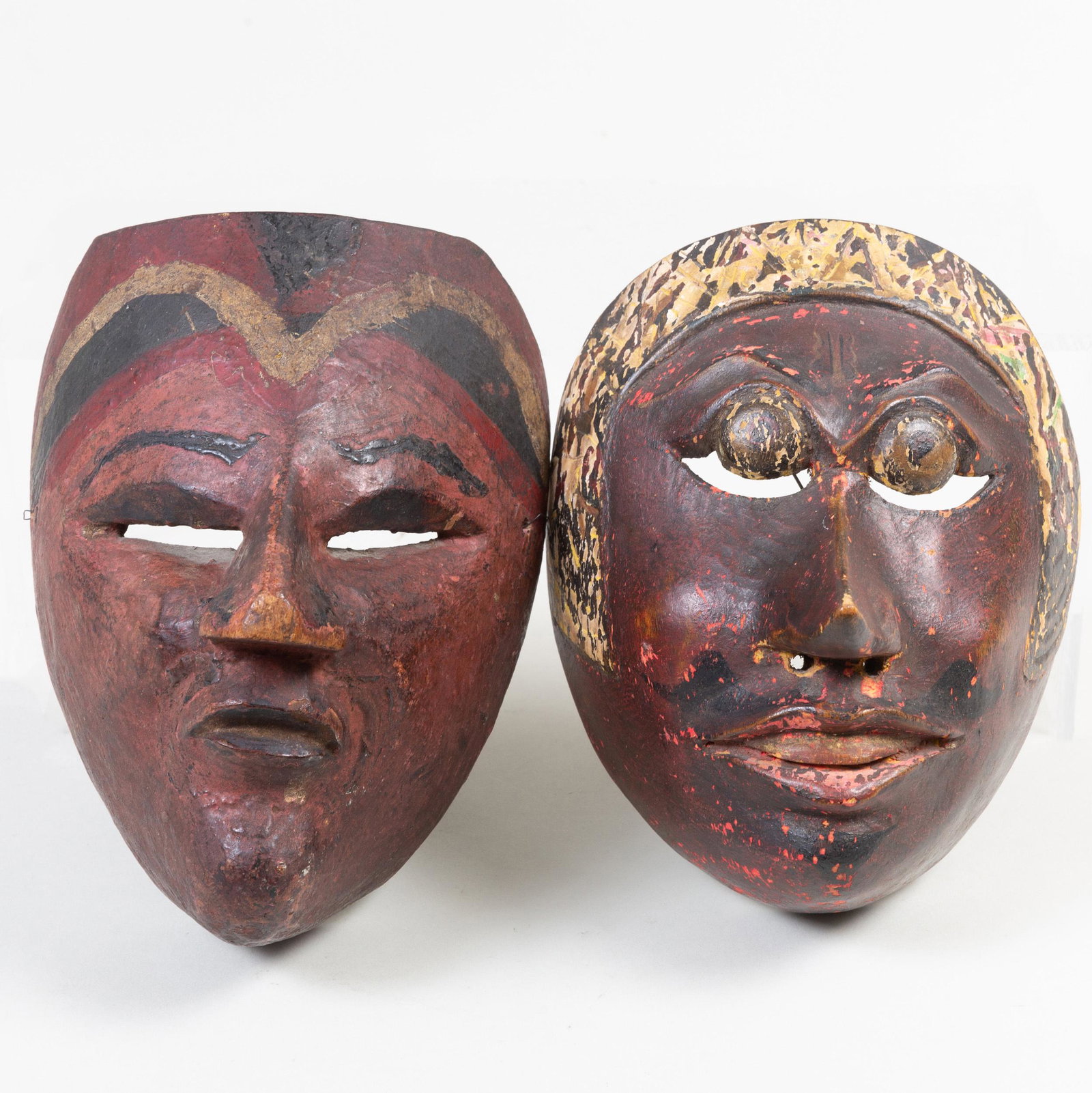 Two Indonesian Painted Wood Masks: Two Indonesian Painted Wood Masks The larger 7 1/4 in. high. Property from the Estate of Martin and Faith-Dorian Wright
