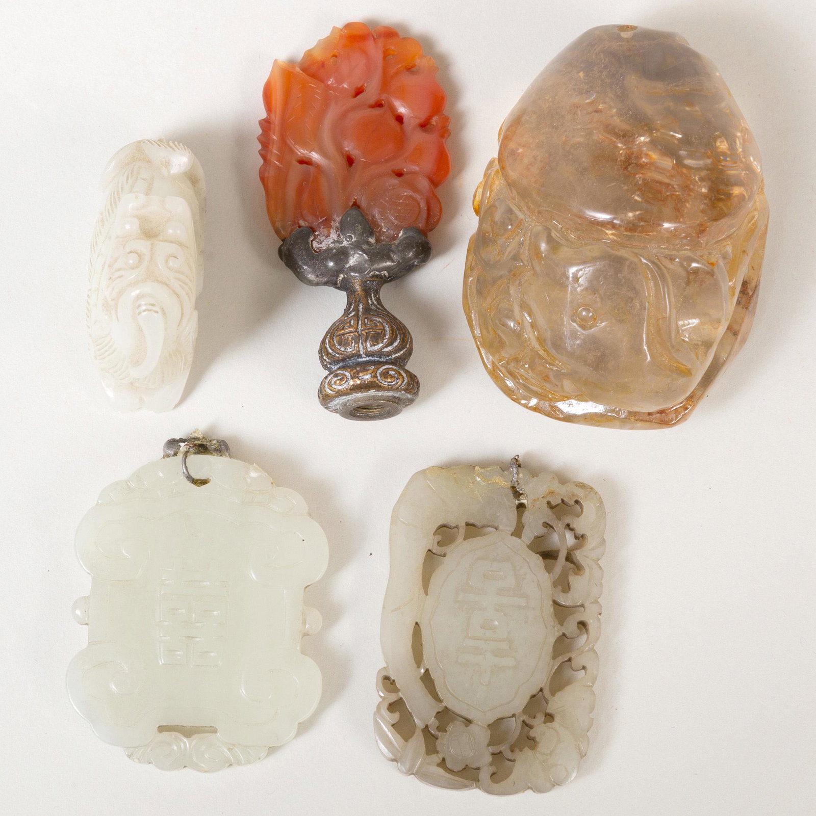 Group of Chinese Pale Green Jade and Hardstone Objects: Group of Chinese Pale Green Jade and Hardstone Objects Comprising: Two plaques with metal mounts A plaque mounted as a lamp finial A carving of a Buddhistic lion An abstract carving The largest 2 3/4 