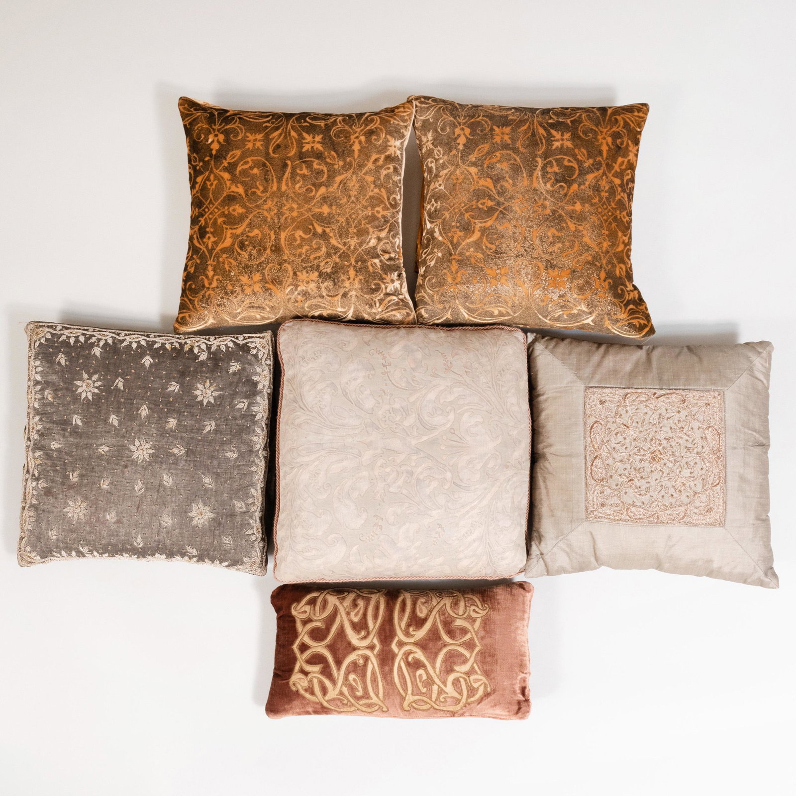 Group of Six Pillows: Group of Six Pillows One with Fortuny fabric, two with Indian grey silk and silver thread embroidery, a pair of orange and brown arabesque designed on crushed velvet and a lumbar velvet pillow with Me