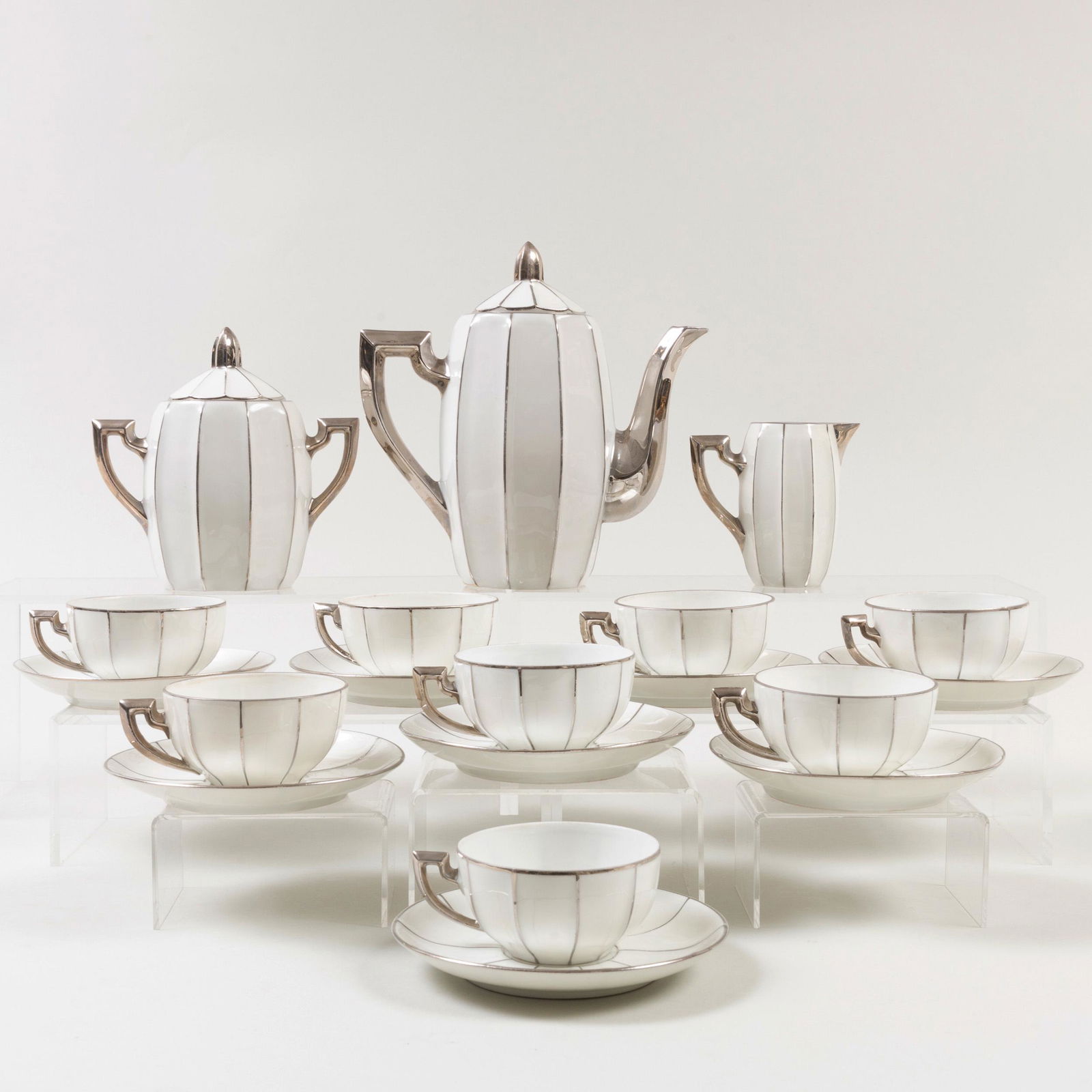 France Art Deco Style Porcelain Tea Service: France Art Deco Style Porcelain Tea Service Impressed 'MS'. Comprising: A teapot and cover A milk jug A sugar bowl and cover Eight cups and saucers The teapot 8 1/2 in. high, (11 pcs). Pr