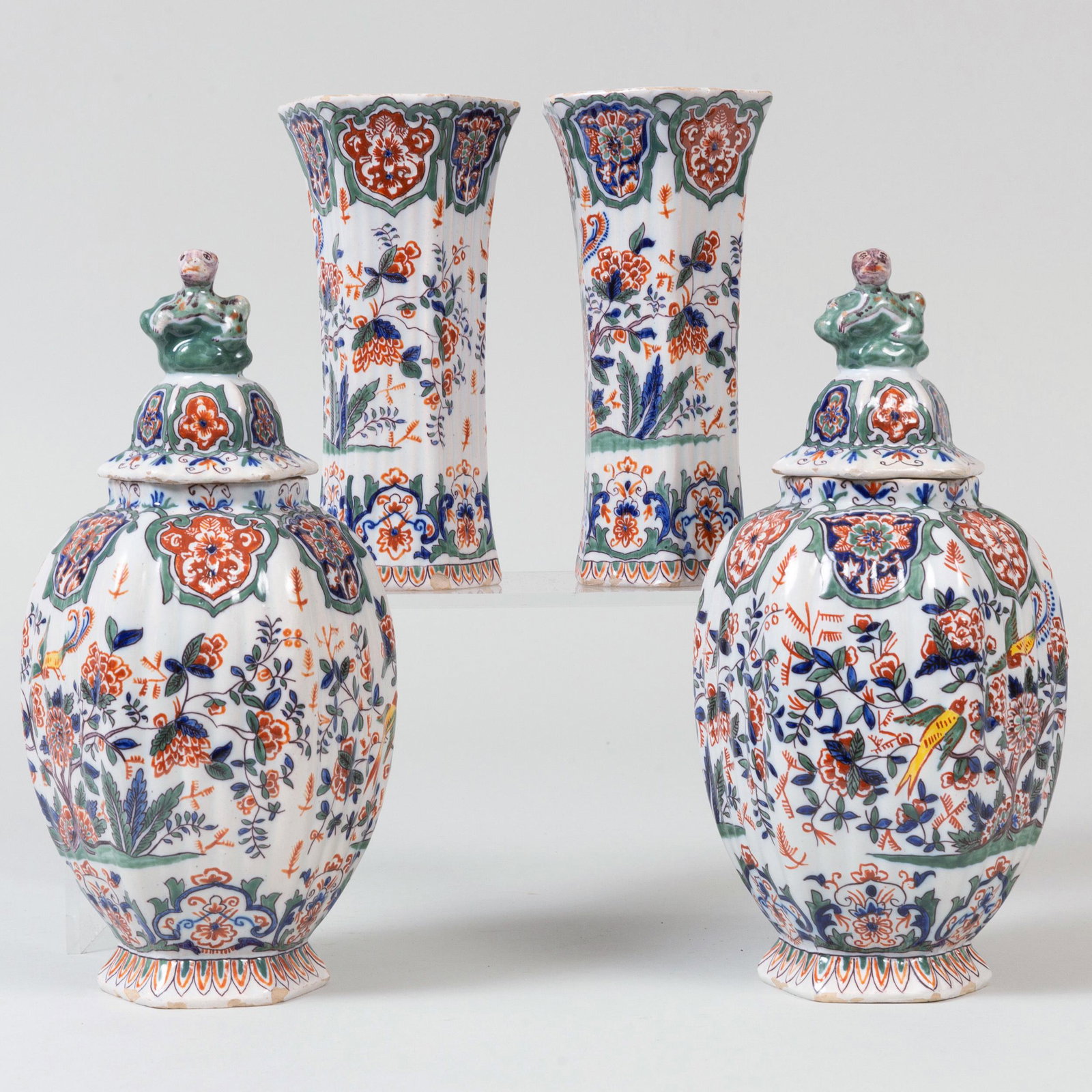 Dutch Polychrome Four Piece Garniture: Dutch Polychrome Four Piece Garniture Iron red painted 'LF'. Comprising: A pair of vases A pair of jars and covers The larger 10 in. high.
