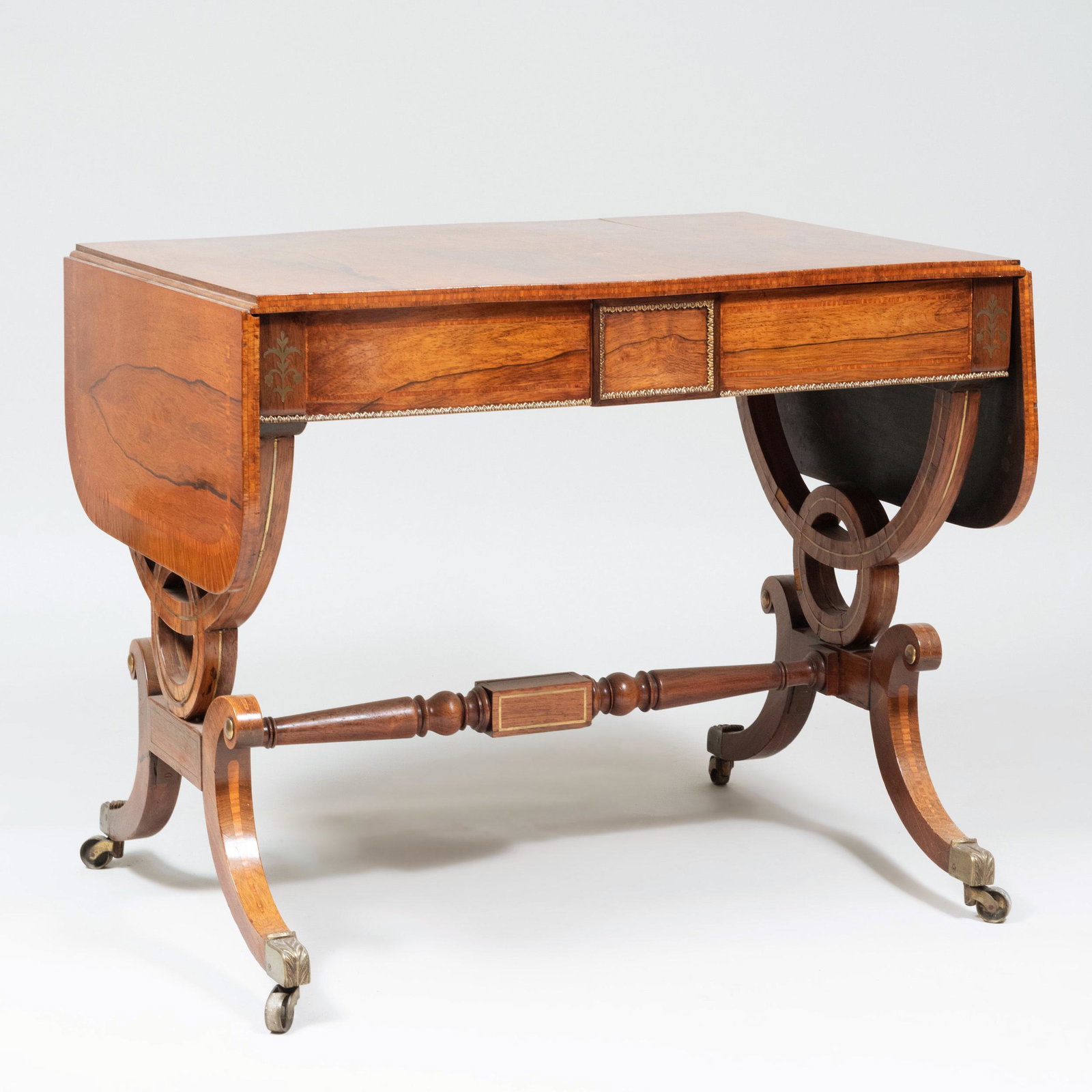 Regency Brass-Inlaid Rosewood Sofa Table: Regency Brass-Inlaid Rosewood Sofa Table Fitted with two drawers, raised on casters. 29 1/2 x 35 1/2 (closed) x 26 in. 4 ft. 10 in. (open)