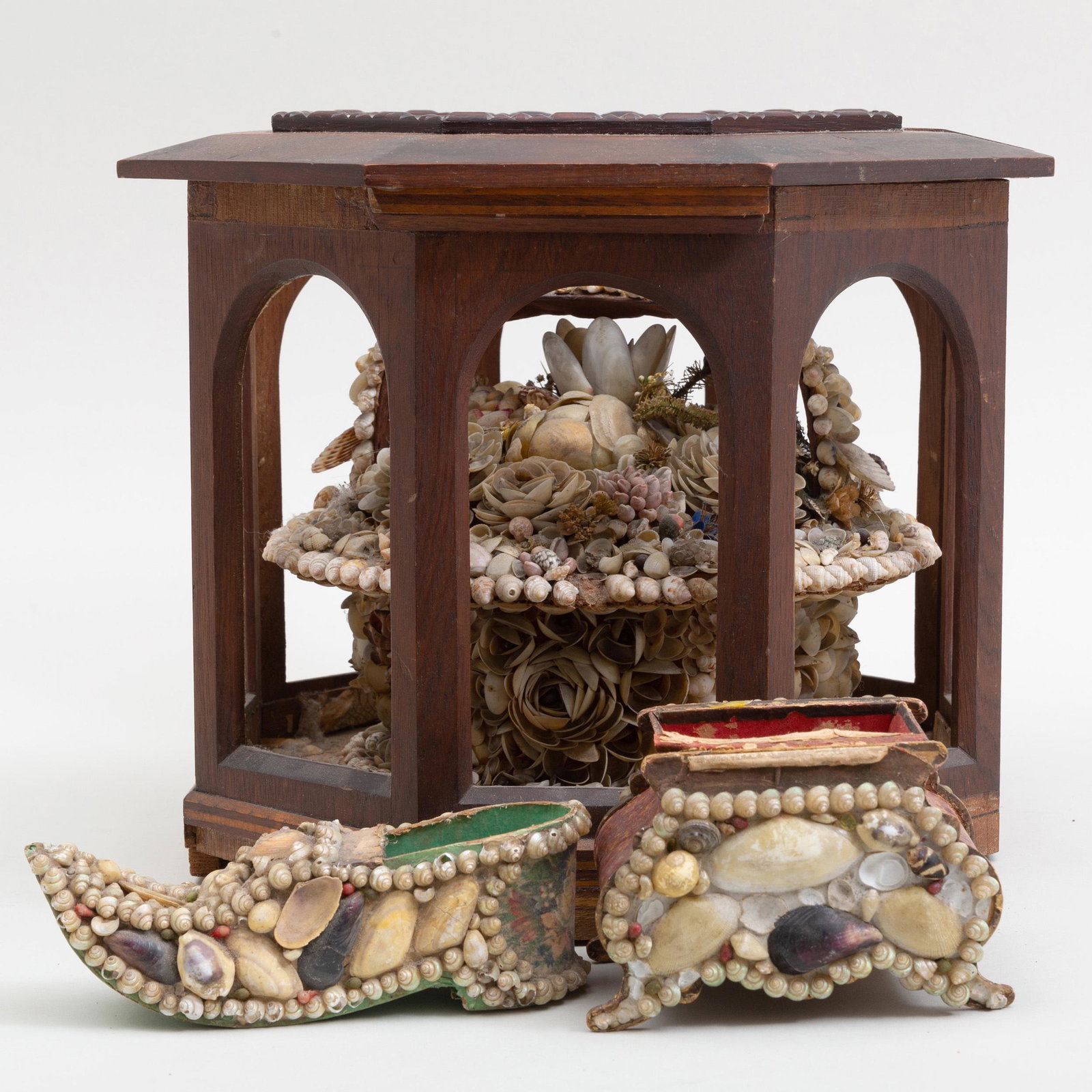 Victorian Shell Basket in an Octagonal Wood Case and: Victorian Shell Basket in an Octagonal Wood Case and Two Shell Decorated Paper Boxes The case inset with glass top, the first paper box shoe form, the second shaped scroll sides. The basket in the w