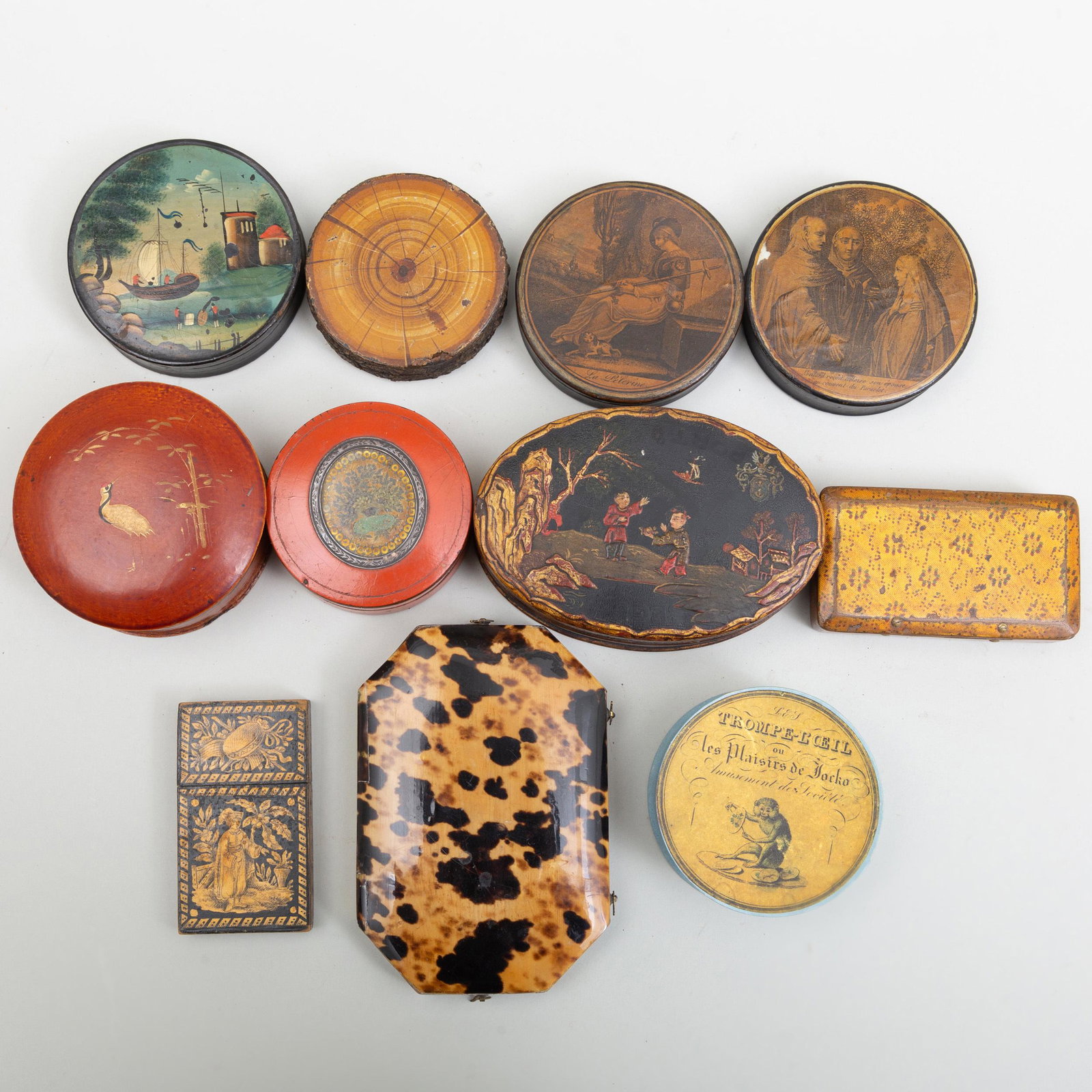 Goup of Eight Snuff Boxes, a Vanity Case and a Vesta: Goup of Eight Snuff Boxes, a Vanity Case and a Vesta Case The snuff boxes papier mâché, one with a faux tortoise hell liner; the vanity case with faux tortoise shell decoration with fitted interior.