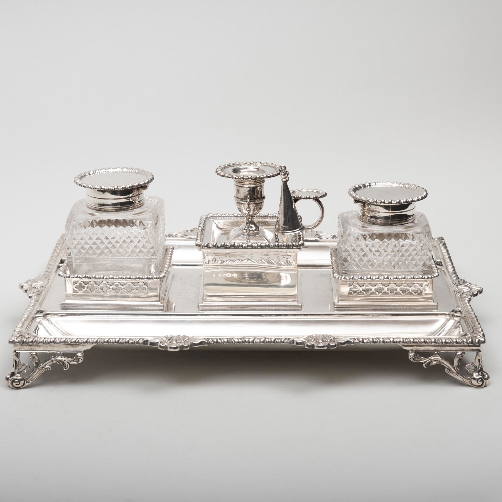 Edward VII Silver Inkstand: Edward VII Silver Inkstand Mark of Charles Stuart Harris, London, 1903. Comprising: Two cut glass inkwells A chamberstick and snuffer 15 1/2 in. long, 63 oz. approx. gross weighable.