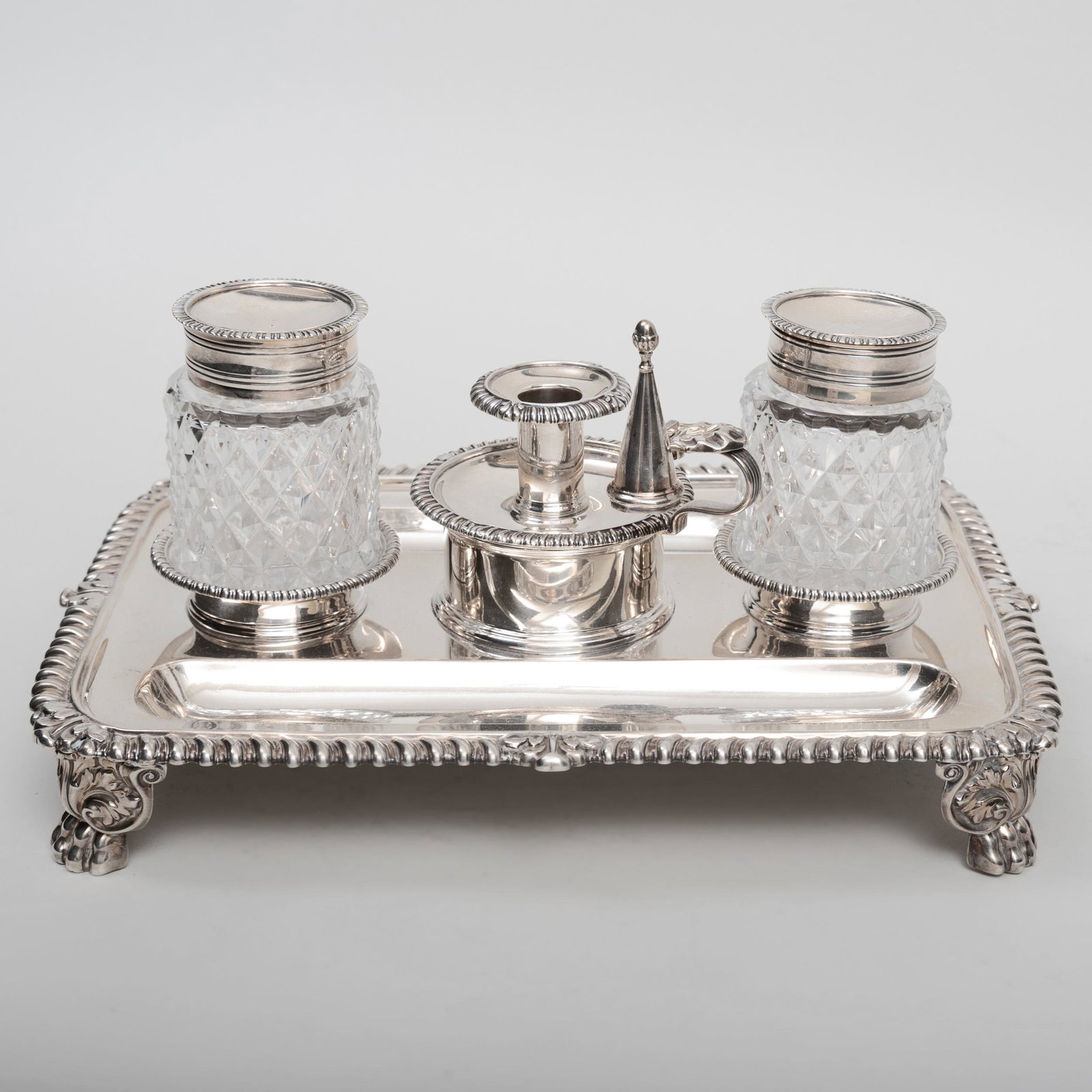 George IV Silver Inkstand: George IV Silver Inkstand Mark of Matthew Boulton, Birmingham, 1827. Comprising: Two cut glass inkpots A chamberstick and snuffer 11 in. wide, 30 oz. approx. gross weight Sold Sotheby's NY, October 24