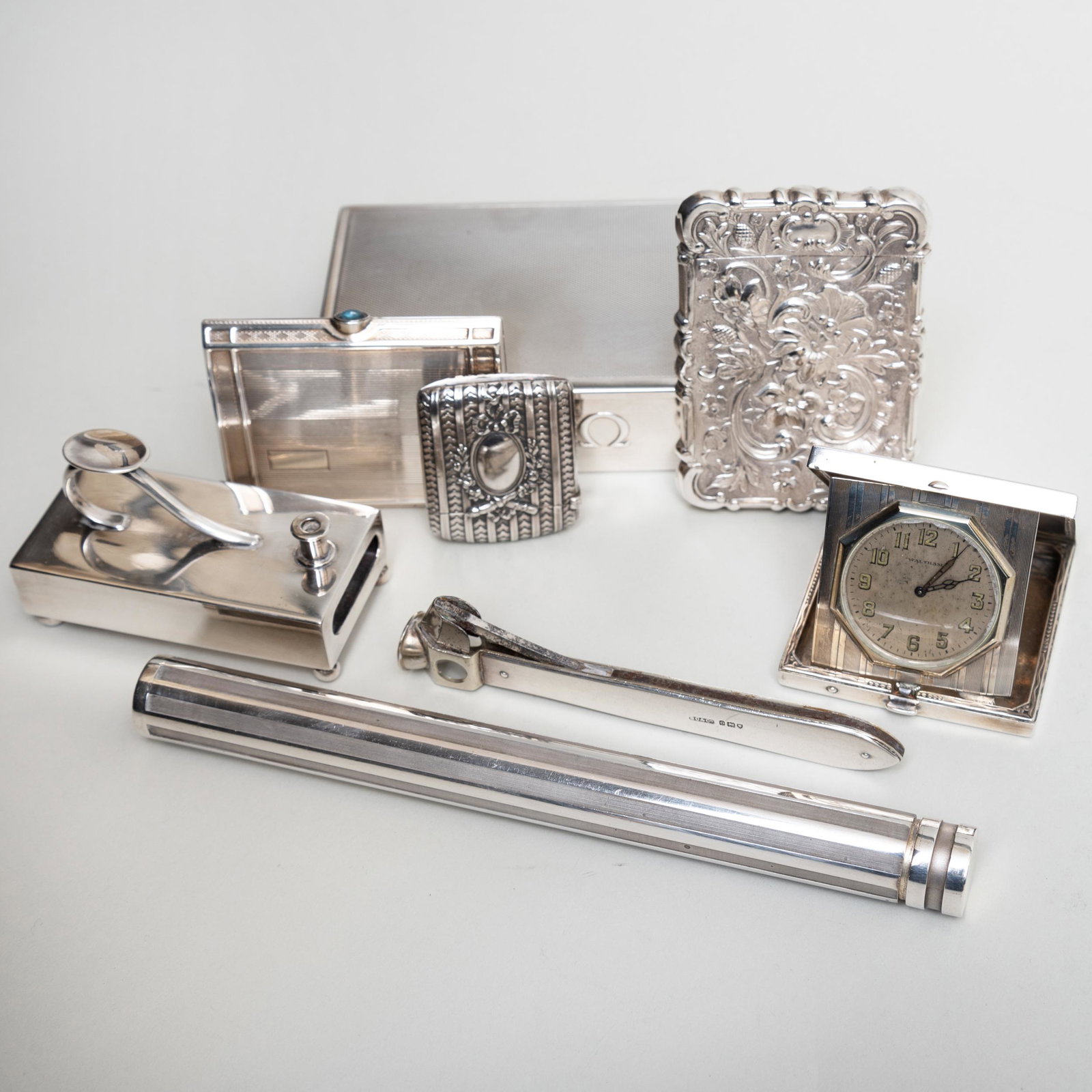 Group of Silver Desk Articles: Group of Silver Desk Articles Comprising: A Tiffany & Co. cigar holder, marked '.925' A Waltham travel clock, marked 'Sterling' A cigarette box, marked 'Sterling' An Elgin silver cigarette case, marke