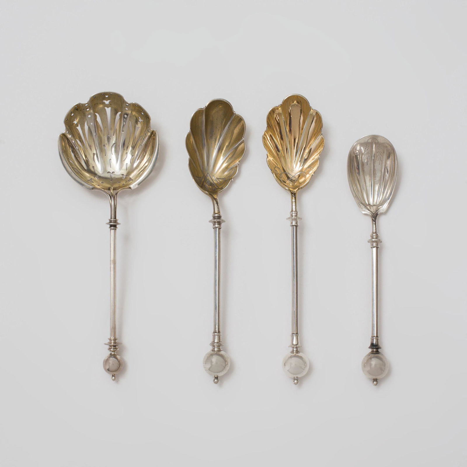 Group of Four George Sharp Silver Dessert Servers: Group of Four George Sharp Silver Dessert Servers Each marked ‘Sterling’. Comprising: A pair of serving spoons with gold wash shell form bowls, also marked 'Patent 1868' and 'GS' A jelly spoon, al