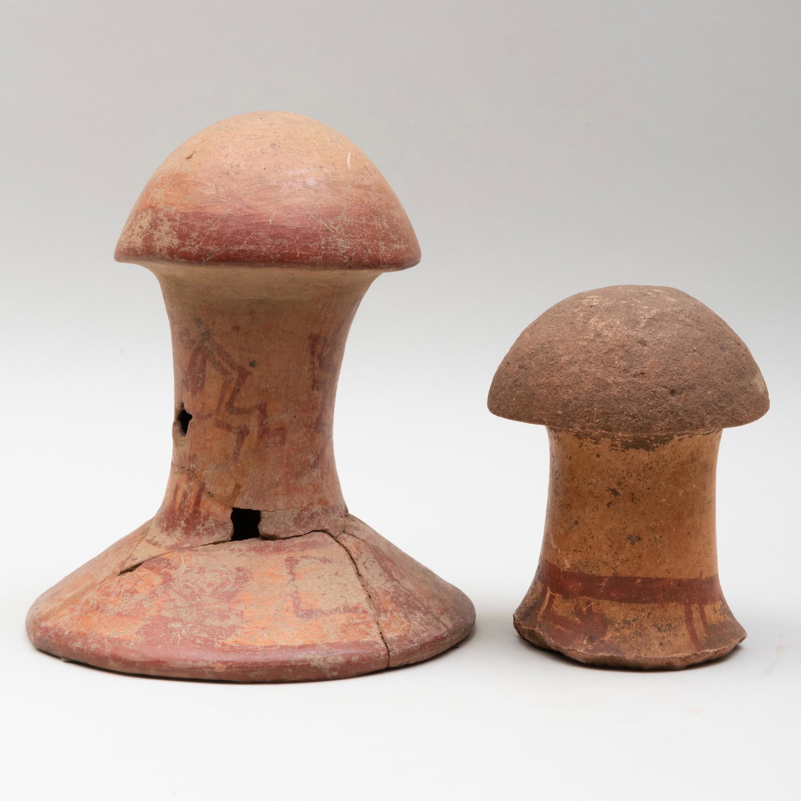Two Mayan Painted Terracotta Mushroom Stones: Two Mayan Painted Terracotta Mushroom Stones The larger 10 3/4 x 9 1/4 in. diam., the smaller 7 1/8 x 5 1/8 in. diam. Note: The intake of hallucinogenic mushrooms in ritual ceremonies was popular amon