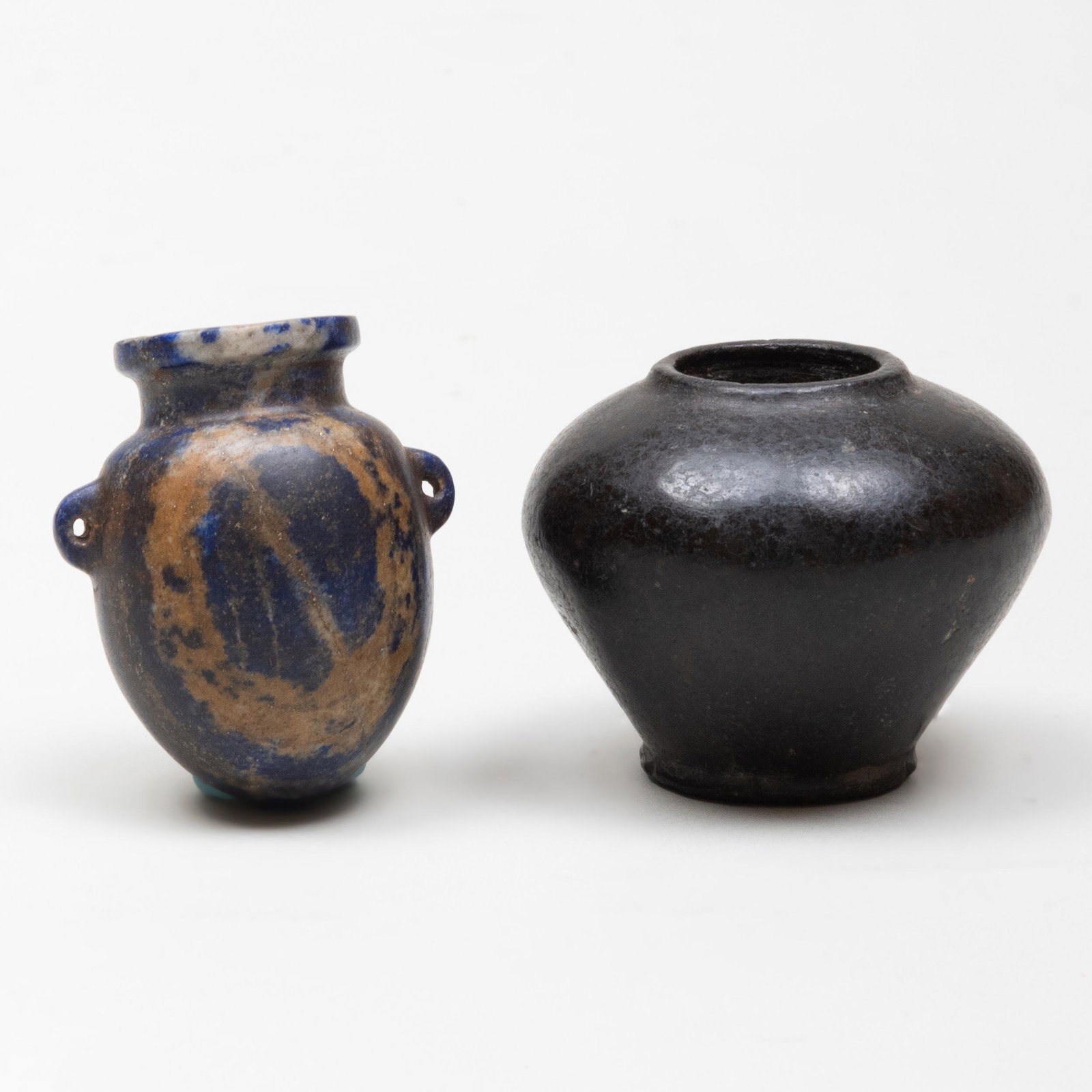 Small Egyptian Stone Cosmetic Jar and a Lapis Lazuli: Small Egyptian Stone Cosmetic Jar and a Lapis Lazuli Amphoriskos The cosmetic jar 1 3/4 x 2 1/4 in. diam., the amphoriskos 2 x 1 5/8 in. diam. Property from the Collection of Tom Swope, Hudson, NY The