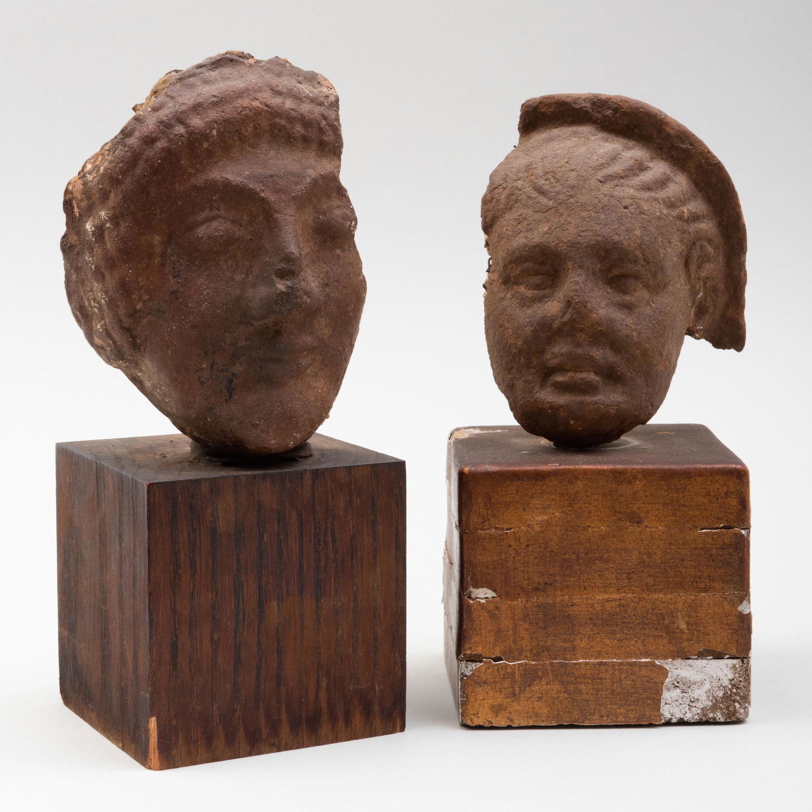 Two Etruscan Terracotta Heads: Two Etruscan Terracotta Heads Both raised on stands. The larger 5 in. high, 8 1/4 in. high (overall). Sold Stair Galleries, Patti Cadby Birch Trust, receipt 9886 # 119...