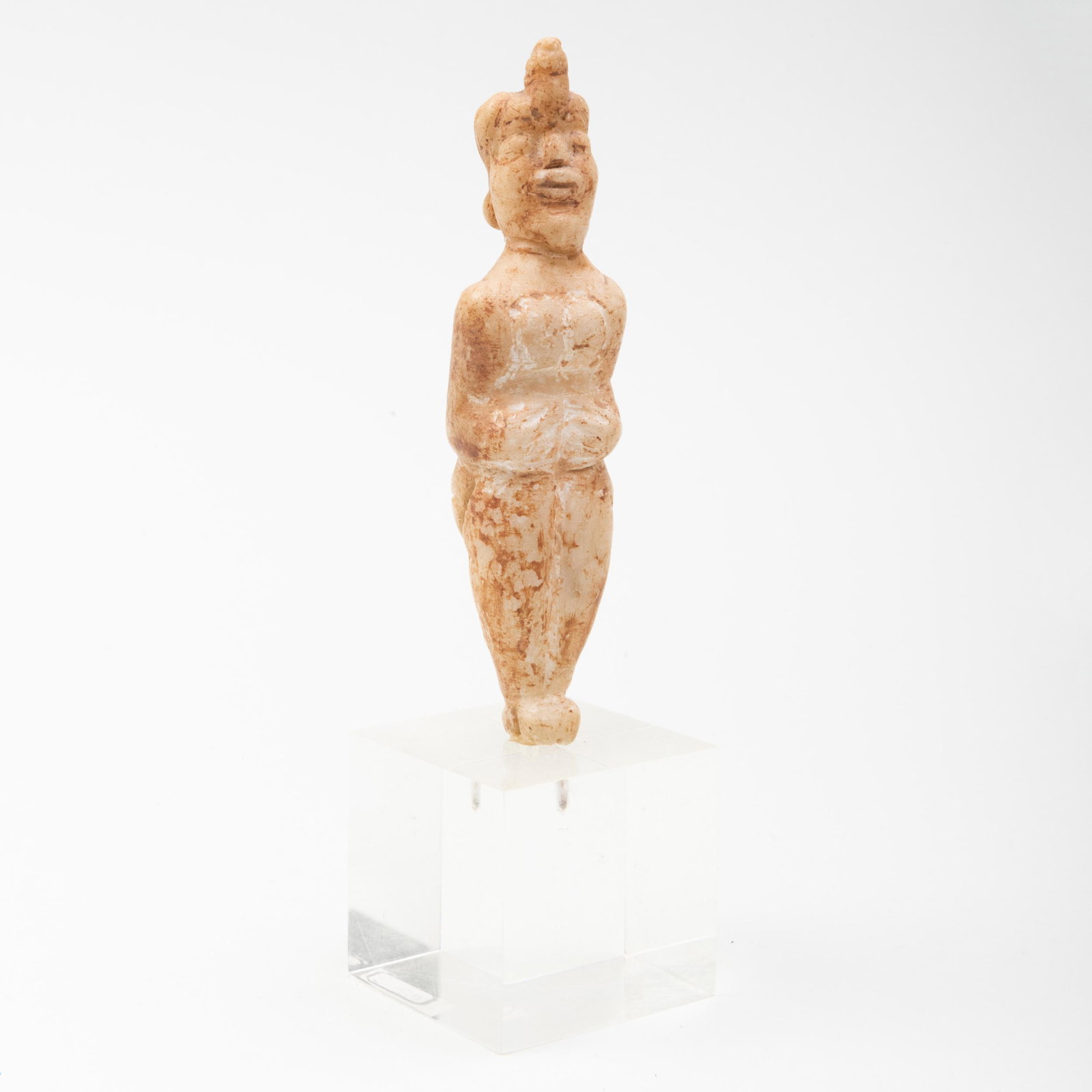 Persian Carved Calcite Figure of a Woman: Persian Carved Calcite Figure of a Woman Carved with a bird on her head, raised on stand. The figure 3 7/8 x 1 x 7/8 in., 5 3/8 in. high (overall). Property from the Collection of Tom Swope, Hudson, N