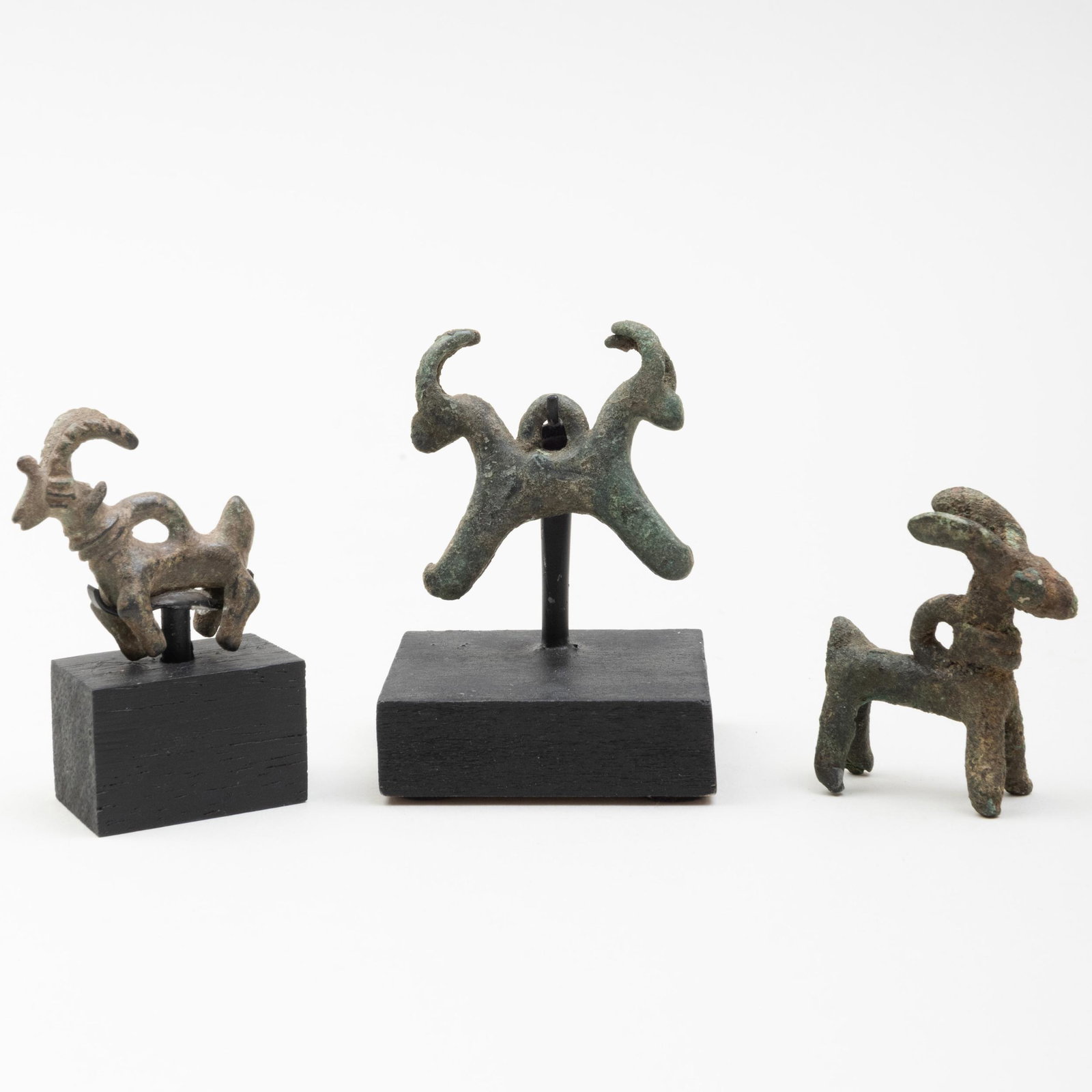 Group of Three Luristan Bronze Ibex Amulets: Group of Three Luristan Bronze Ibex Amulets Two raised on stands. The largest figure 1 1/2 x 1 3/8 in. Property from the Collection of Tom Swope, Hudson, NY Sold Stair Galleries, Patti Cadby Birch Tru