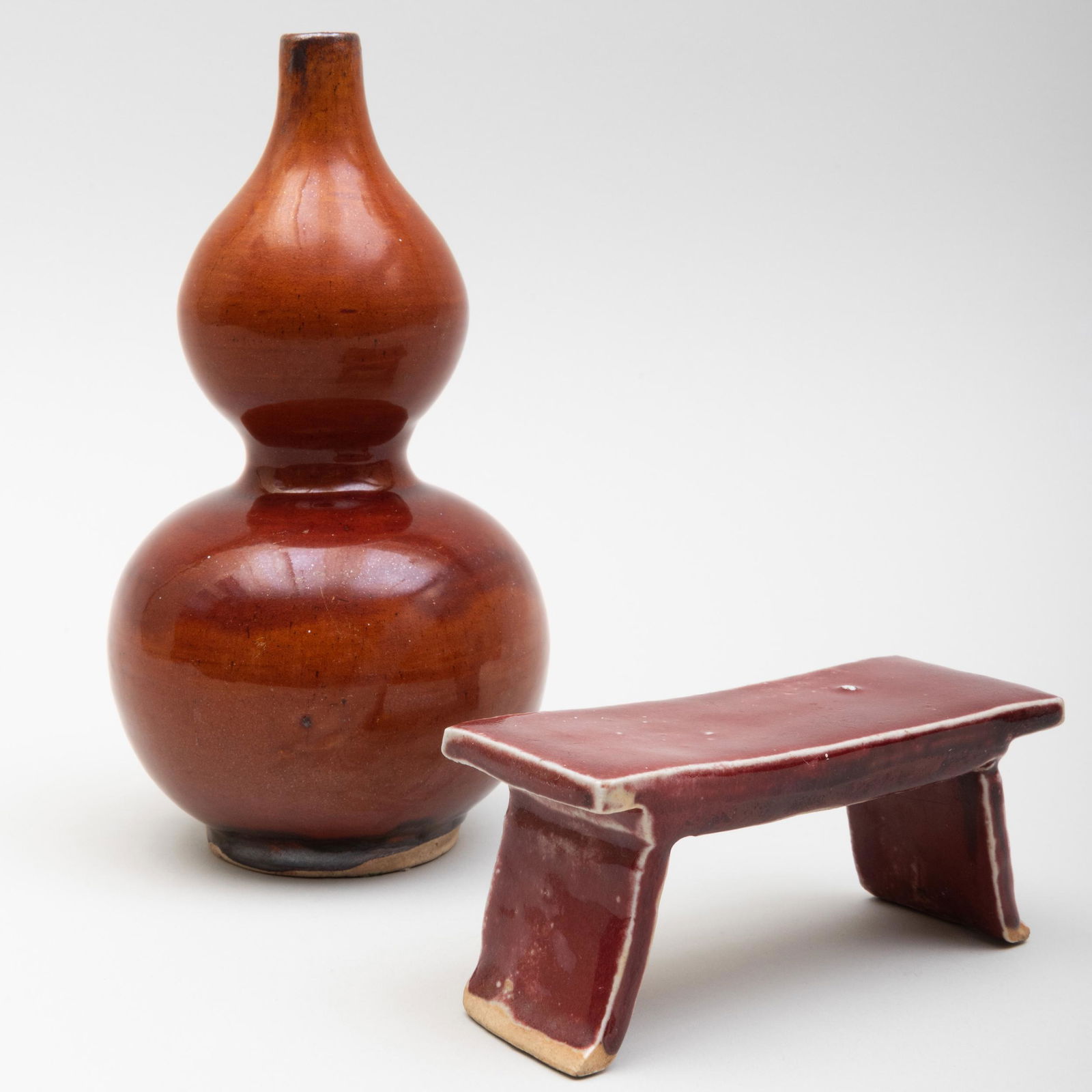 Chinese Brown Gazed Porcelain Double Gourd Vase and an: Chinese Brown Gazed Porcelain Double Gourd Vase and an Copper Red Model of Altar Table The vase 8 in. high, table 5 1/4 in. long.