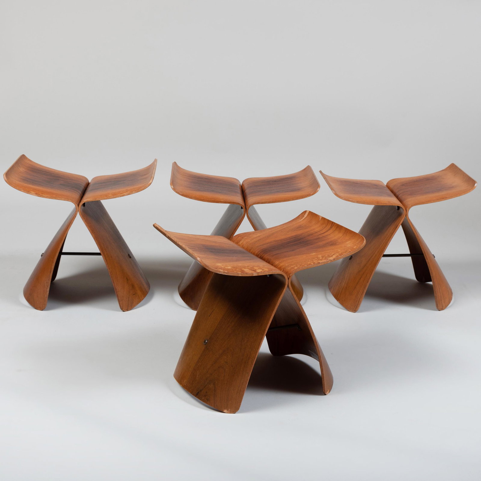 Set of Four Sori Yanagi Brass-Mounted Rosewood and: Set of Four Sori Yanagi Brass-Mounted Rosewood and Plywood 'Butterfly' Stools Each with a small paper label underneath, two marked # 4 & # 20, the others have faded. 16 x 16 1/2 x 12 in.