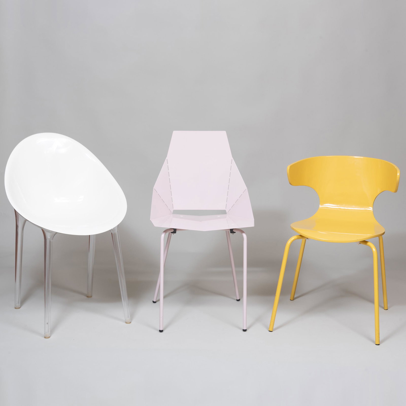 Group of Nine Modern Chairs: Group of Nine Modern Chairs Comprising: A set of three pale pink powder coated metal chairs A set of three West Elm yellow painted resin and metal chairs A set of three acrylic and lucite 'egg' chai