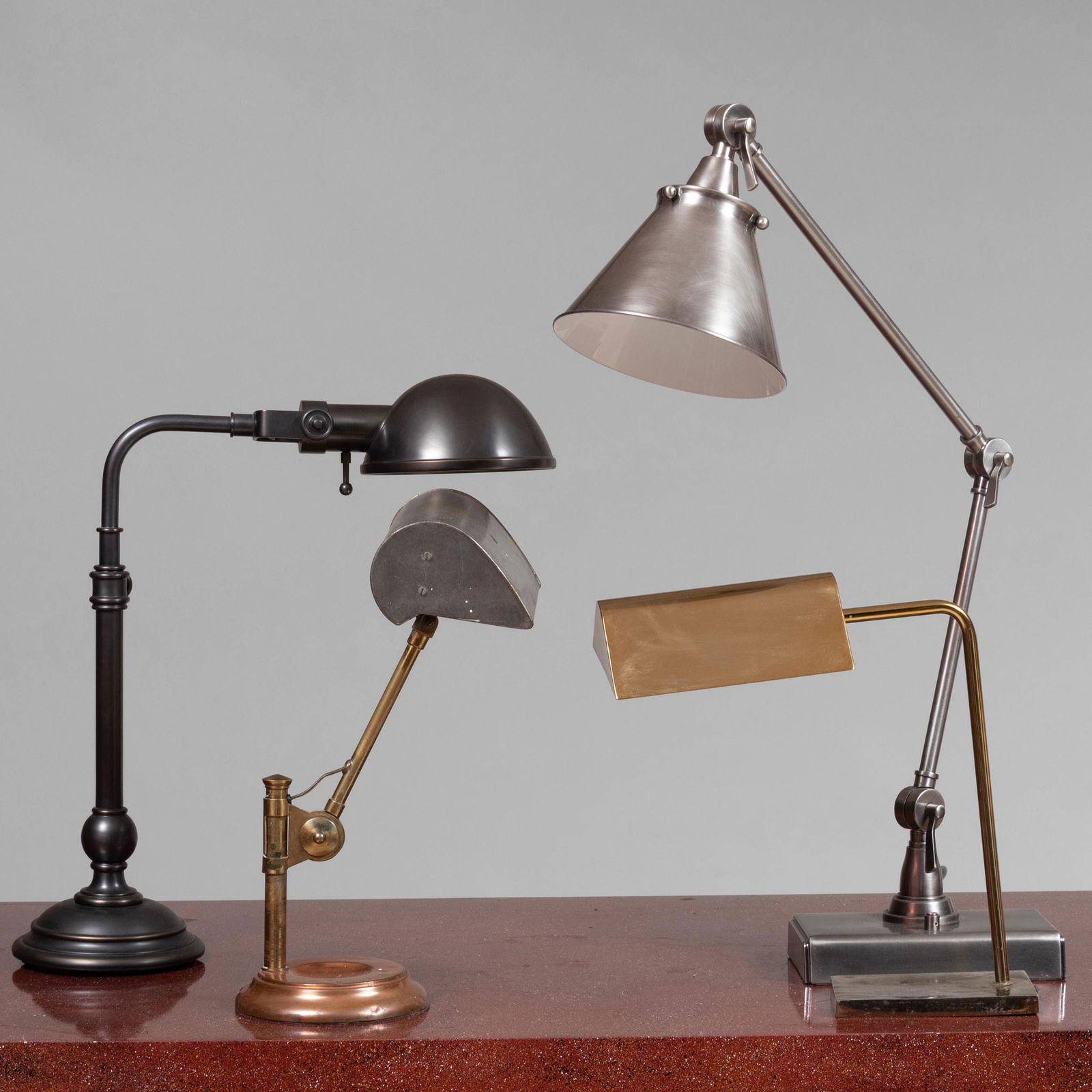 Group of Four Mixed Metal Desk Lamps: Group of Four Mixed Metal Desk Lamps Two retractable. The largest 22 in. high. John Richardson: A Scholar Collects
