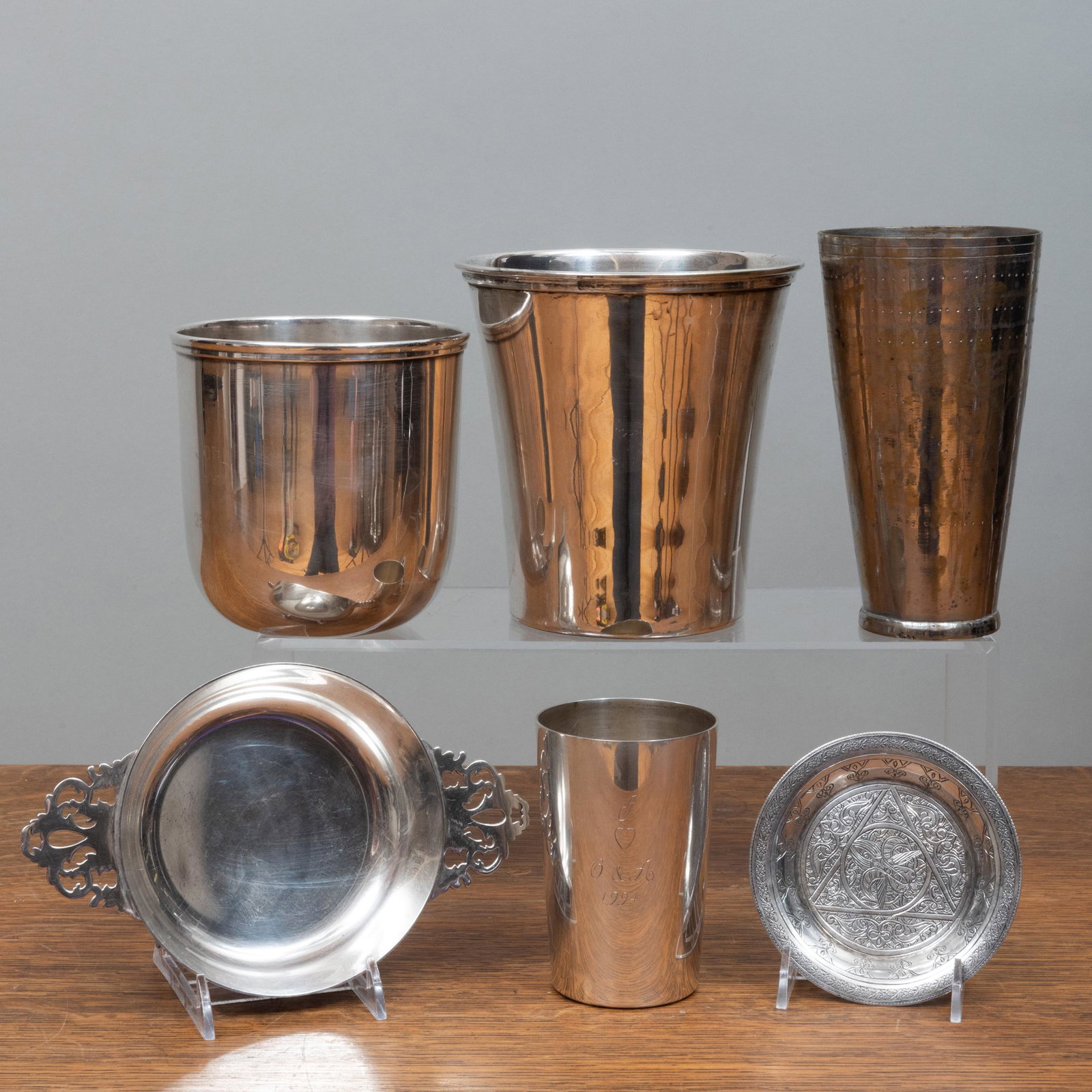 English Silver Beakers and a Group of Vessels: English Silver Beakers and a Group of Vessels The beaker mark of Solomon Joel Phillips, London, 1994; inscribed 'J' over a heart over 'O & A, 1994'. The vessels comprising: A silver plate bowl inscri